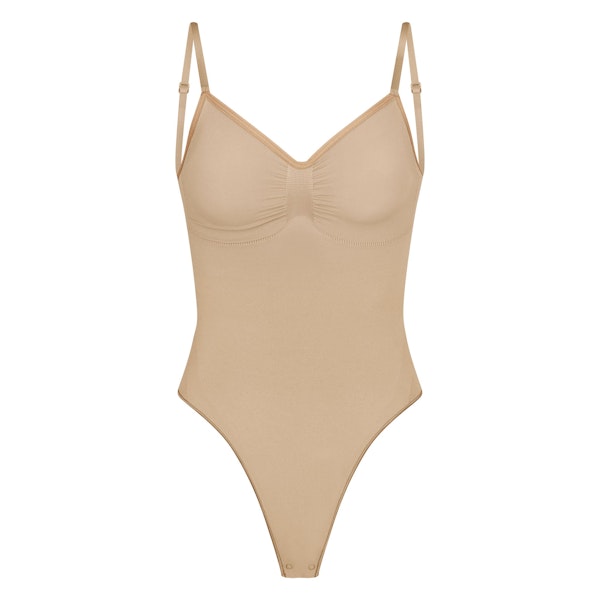 SEAMLESS SCULPT LOW BACK THONG BODYSUIT | CLAY (LOW BACK SHAPEWEAR, BODYSUITS) LAYS FLAT ON A WHITE BACKGROUND | FLT