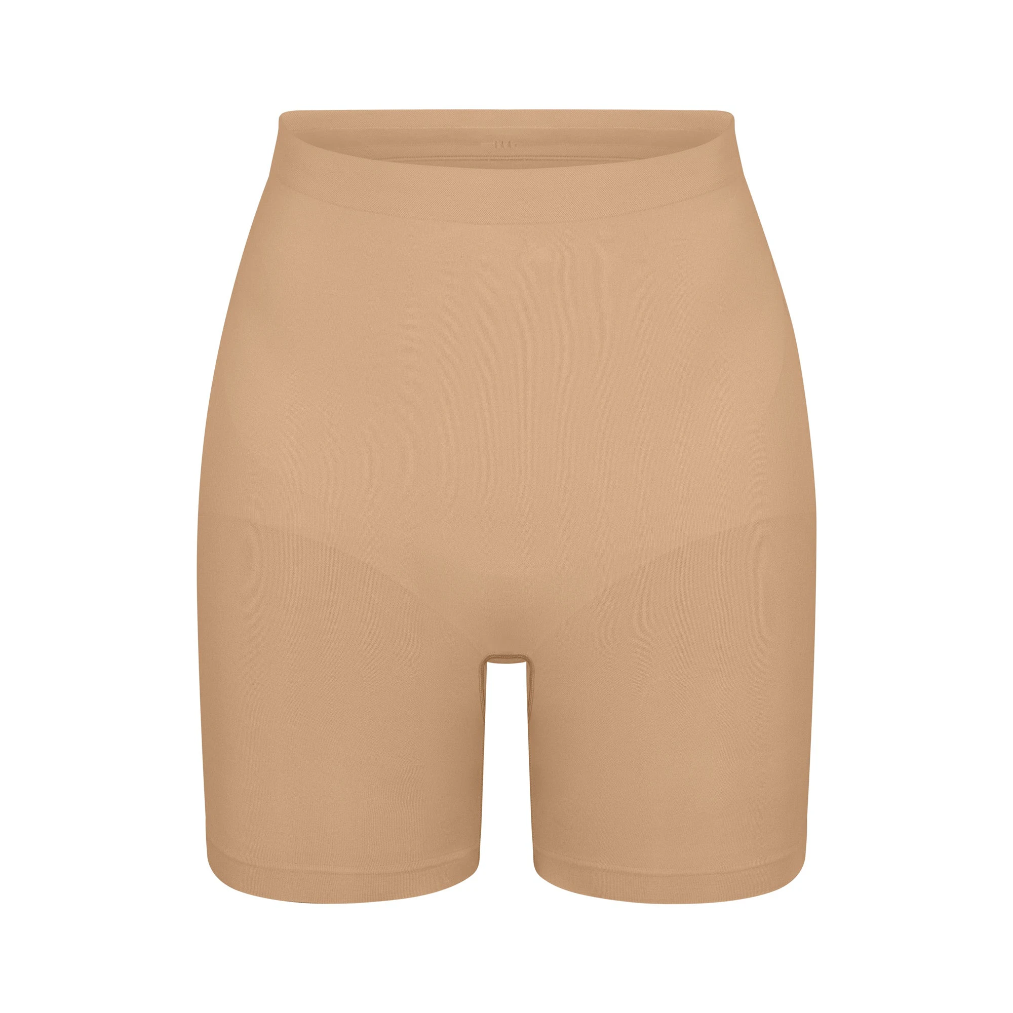 SEAMLESS SCULPT MID THIGH SHORT | CLAY (SHAPEWEAR SHORTS, SHAPEWEAR) LAYS FLAT ON A WHITE BACKGROUND | FLT