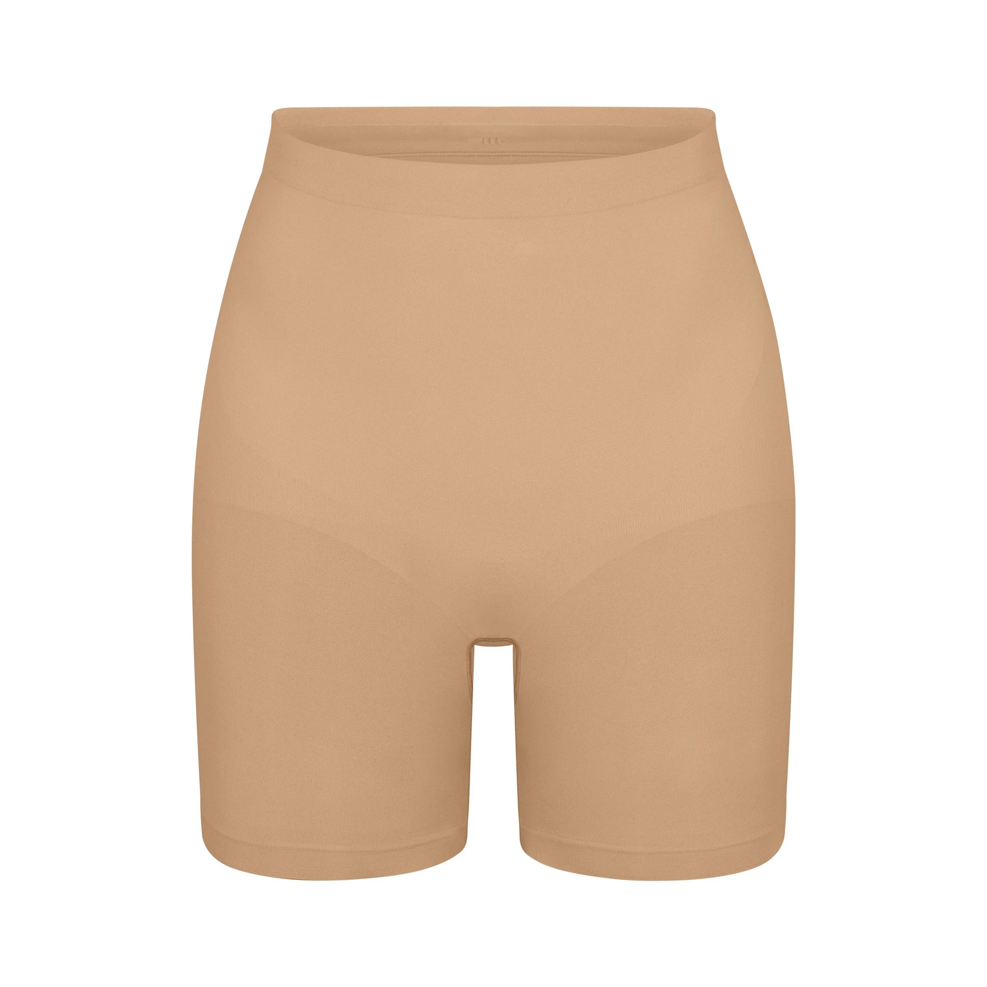 SEAMLESS SCULPT MID THIGH SHORT | CLAY (SHAPEWEAR SHORTS, SHAPEWEAR) LAYS FLAT ON A WHITE BACKGROUND | FLT