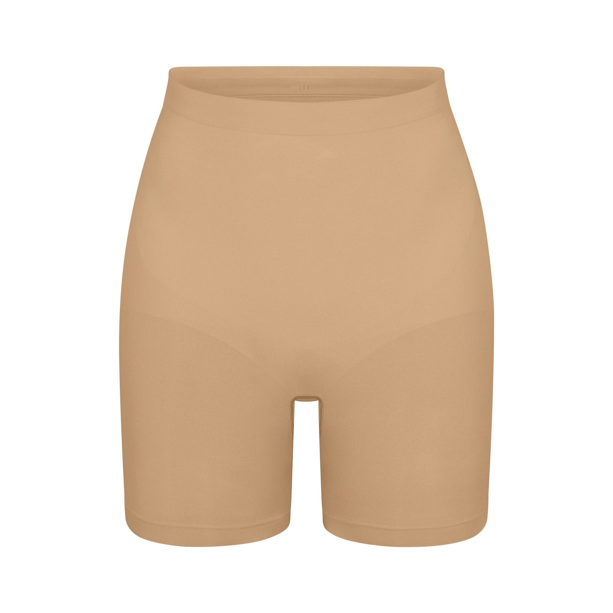 SEAMLESS SCULPT MID THIGH SHORT | CLAY (SHAPEWEAR SHORTS, SHAPEWEAR) LAYS FLAT ON A WHITE BACKGROUND | FLT