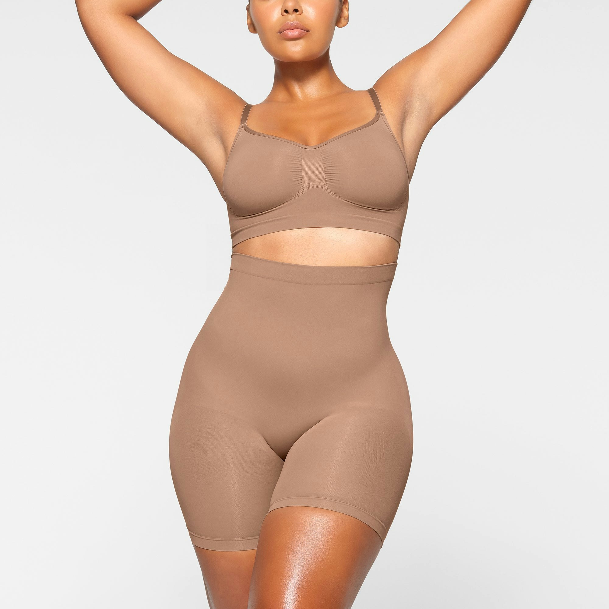SEAMLESS SCULPT MID THIGH SHORT WORN BY A MODEL IN FRONT VIEW | SEE: M, L, XL