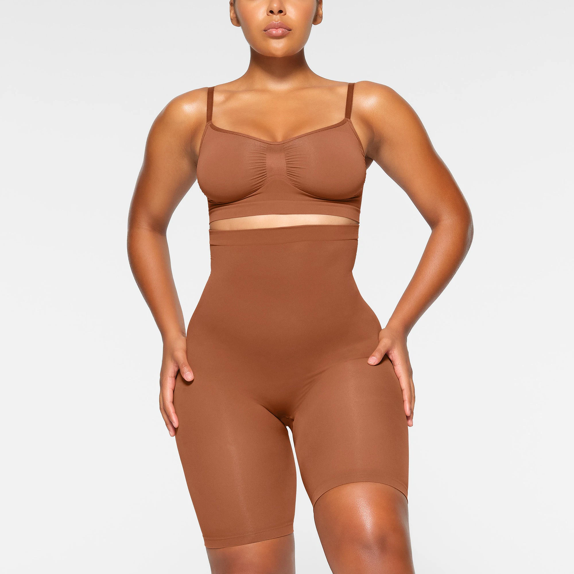 SEAMLESS SCULPT HIGH-WAISTED ABOVE THE KNEE SHORT WORN BY A MODEL IN FRONT VIEW | SEE: M, L, XL