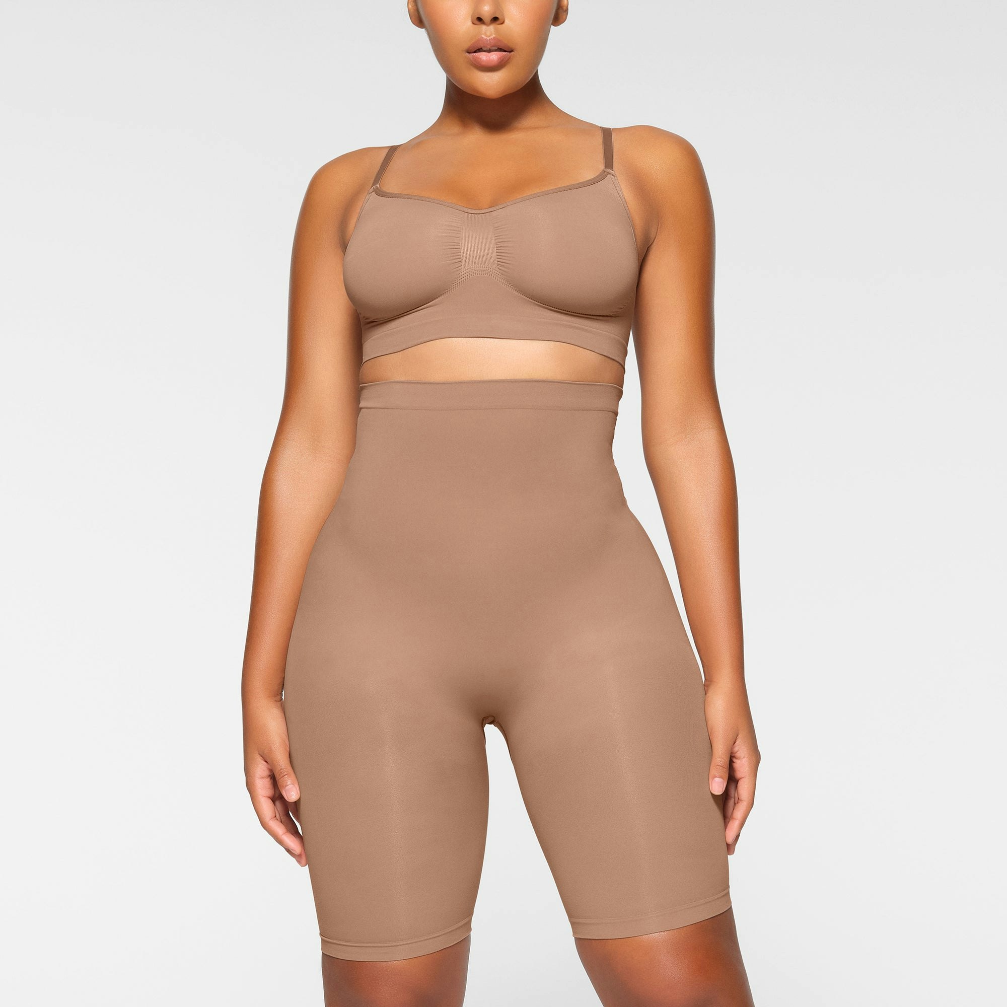 SEAMLESS SCULPT HIGH-WAISTED ABOVE THE KNEE SHORT WORN BY A MODEL IN FRONT VIEW | SEE: M, L, XL