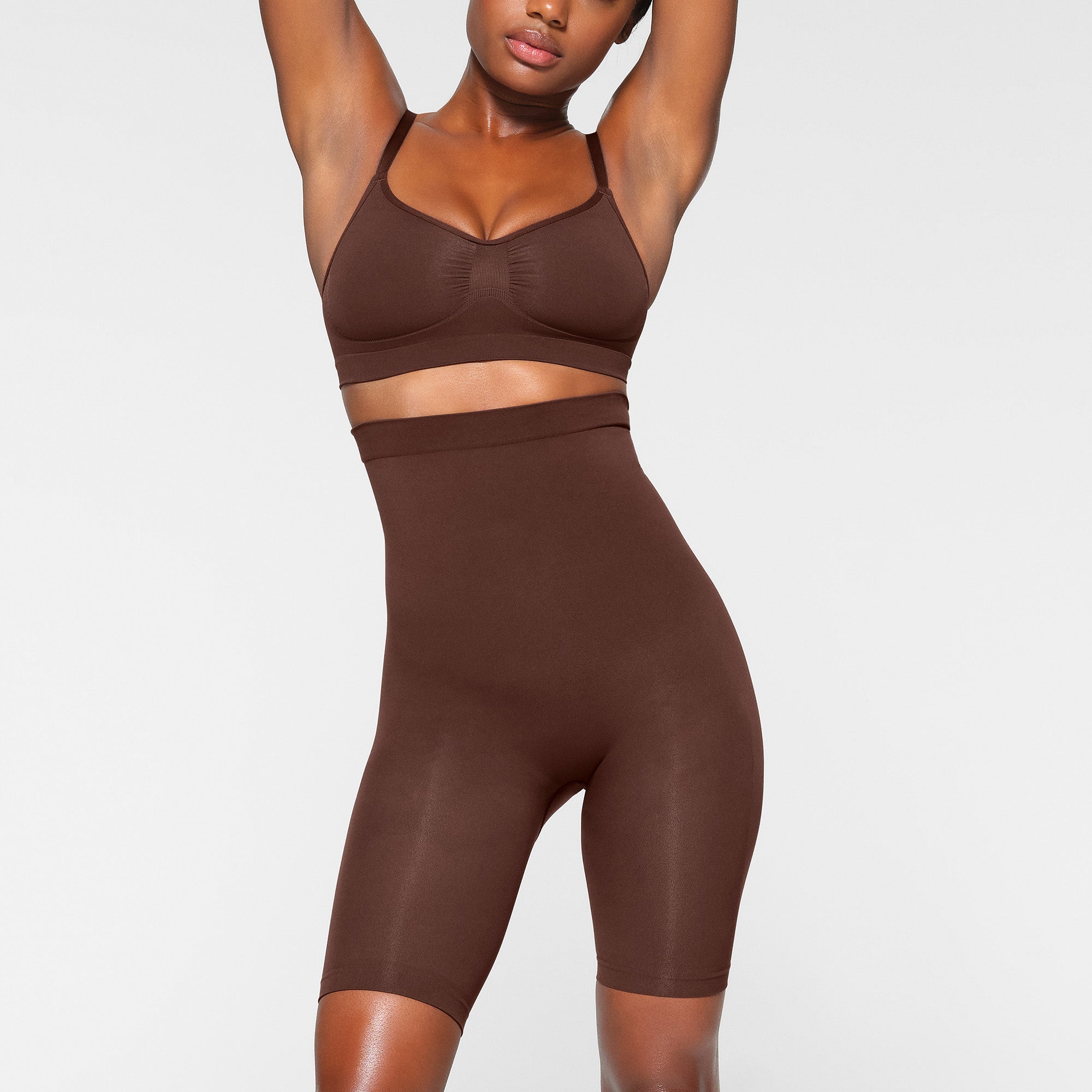 SEAMLESS SCULPT HIGH-WAISTED ABOVE THE KNEE SHORT WORN BY A MODEL IN FRONT VIEW | SEE: XXS, XS, S