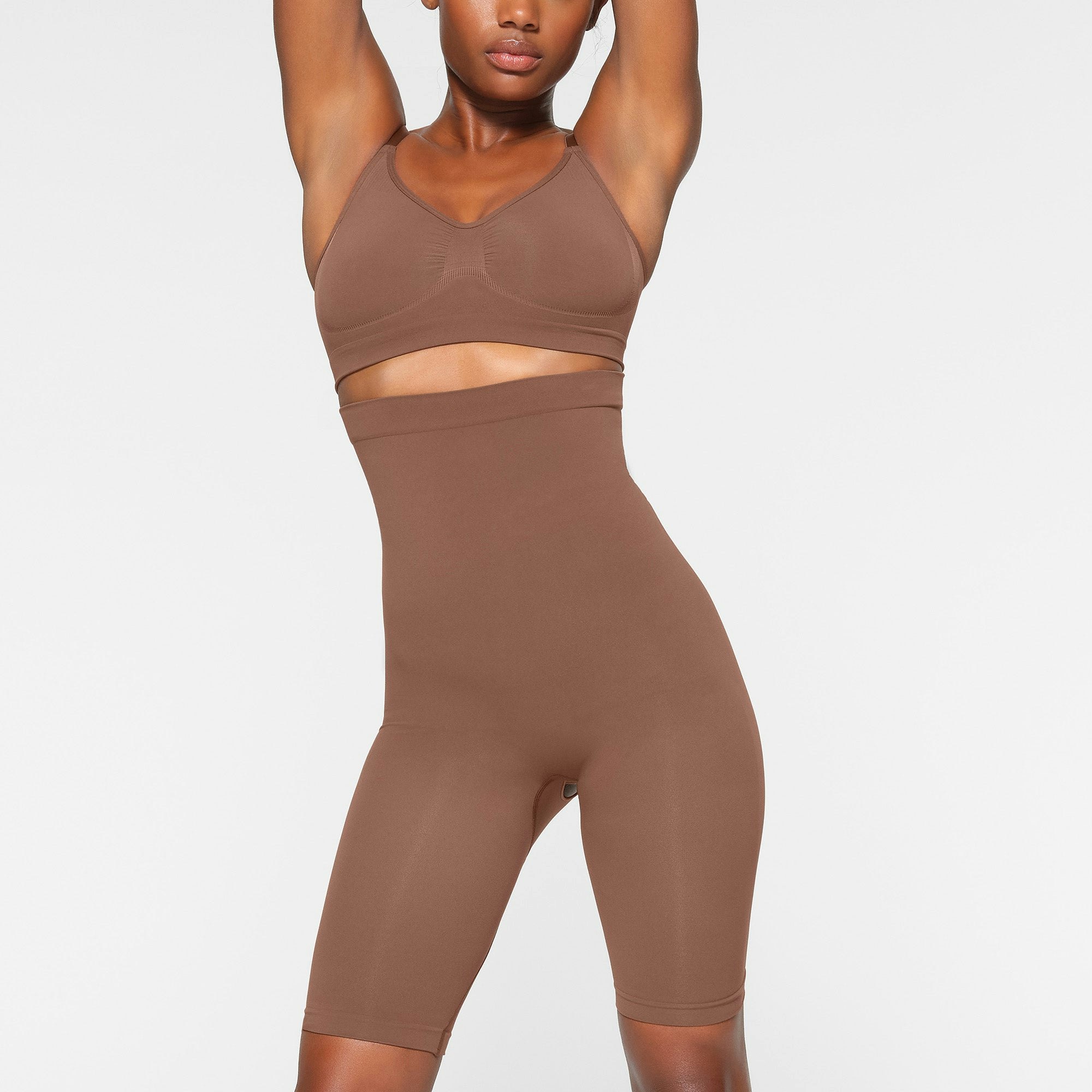 SEAMLESS SCULPT HIGH-WAISTED ABOVE THE KNEE SHORT WORN BY A MODEL IN FRONT VIEW | SEE: XXS, XS, S