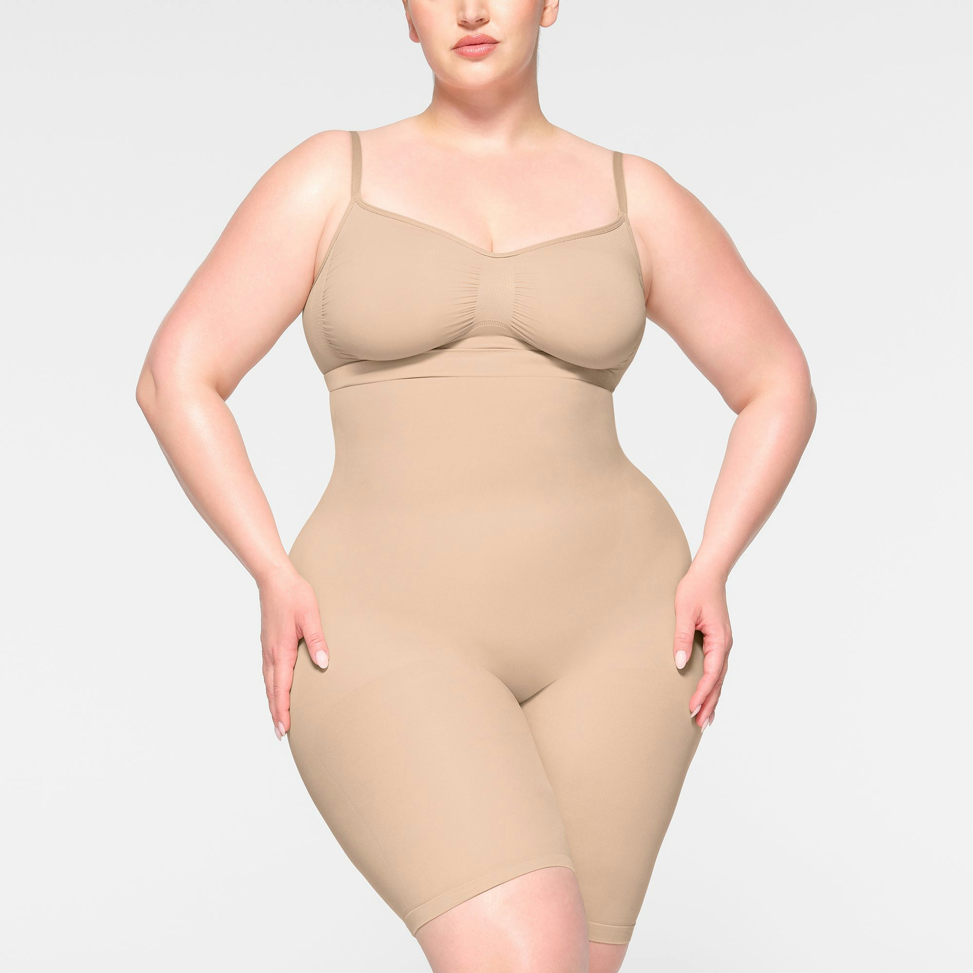 SEAMLESS SCULPT HIGH-WAISTED ABOVE THE KNEE SHORT WORN BY A MODEL IN FRONT VIEW | SEE: 2X, 3X, 4X