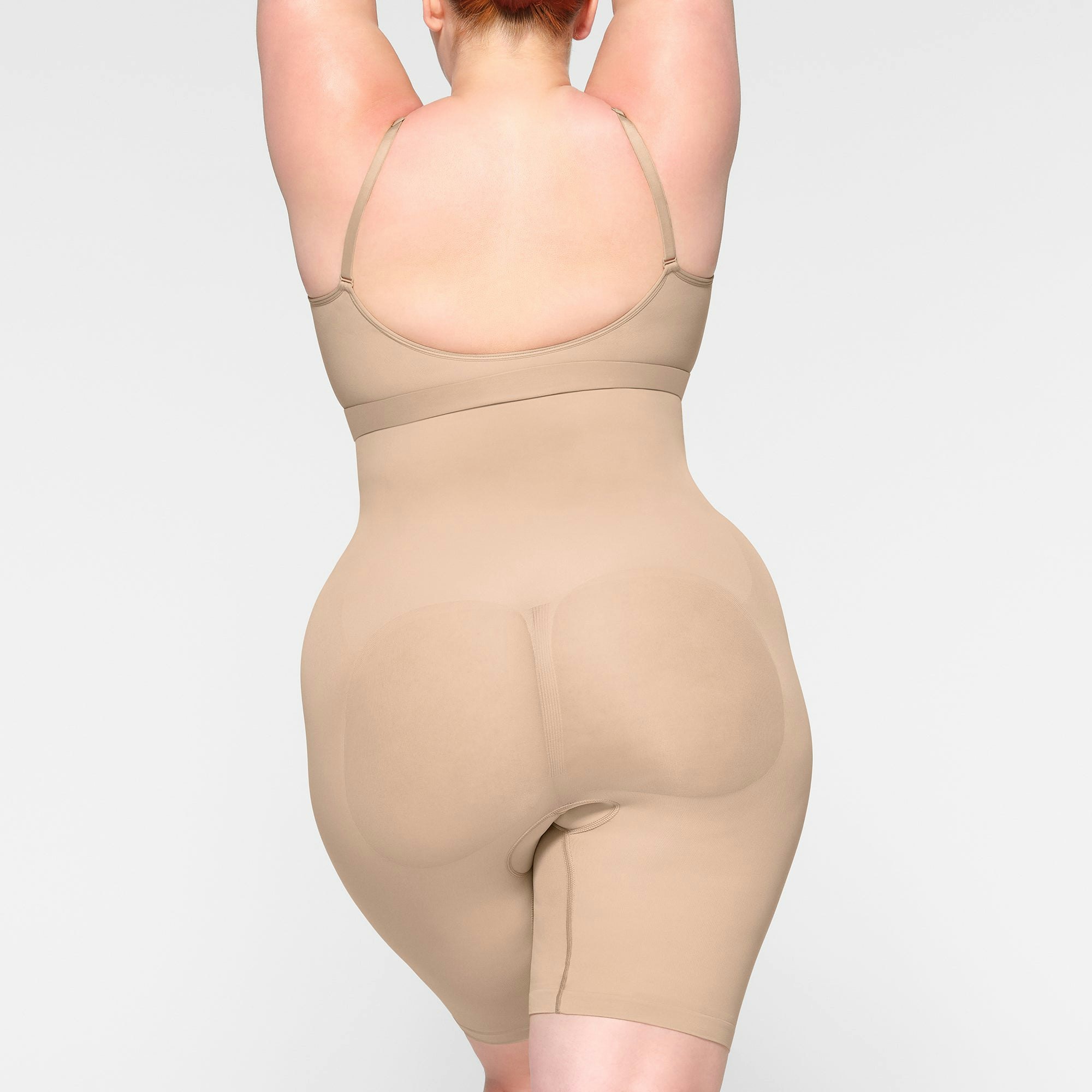 SEAMLESS SCULPT HIGH-WAISTED ABOVE THE KNEE SHORT ON A MODEL BACK VIEW