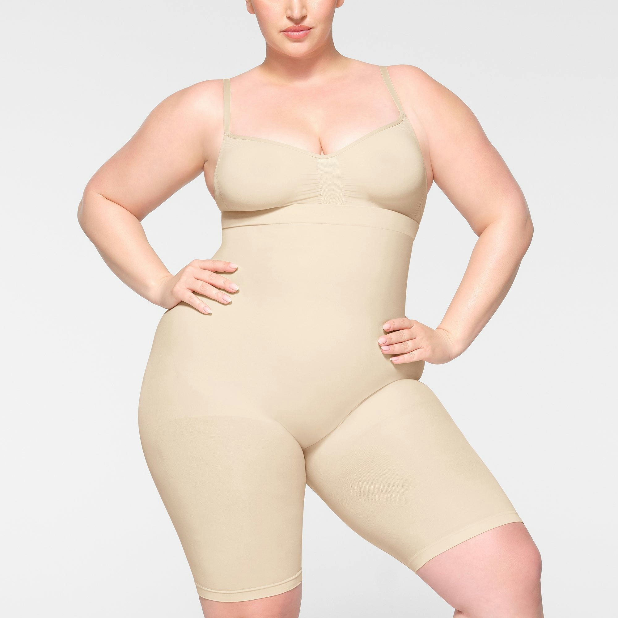 SEAMLESS SCULPT HIGH-WAISTED ABOVE THE KNEE SHORT WORN BY A MODEL IN FRONT VIEW | SEE: 2X, 3X, 4X