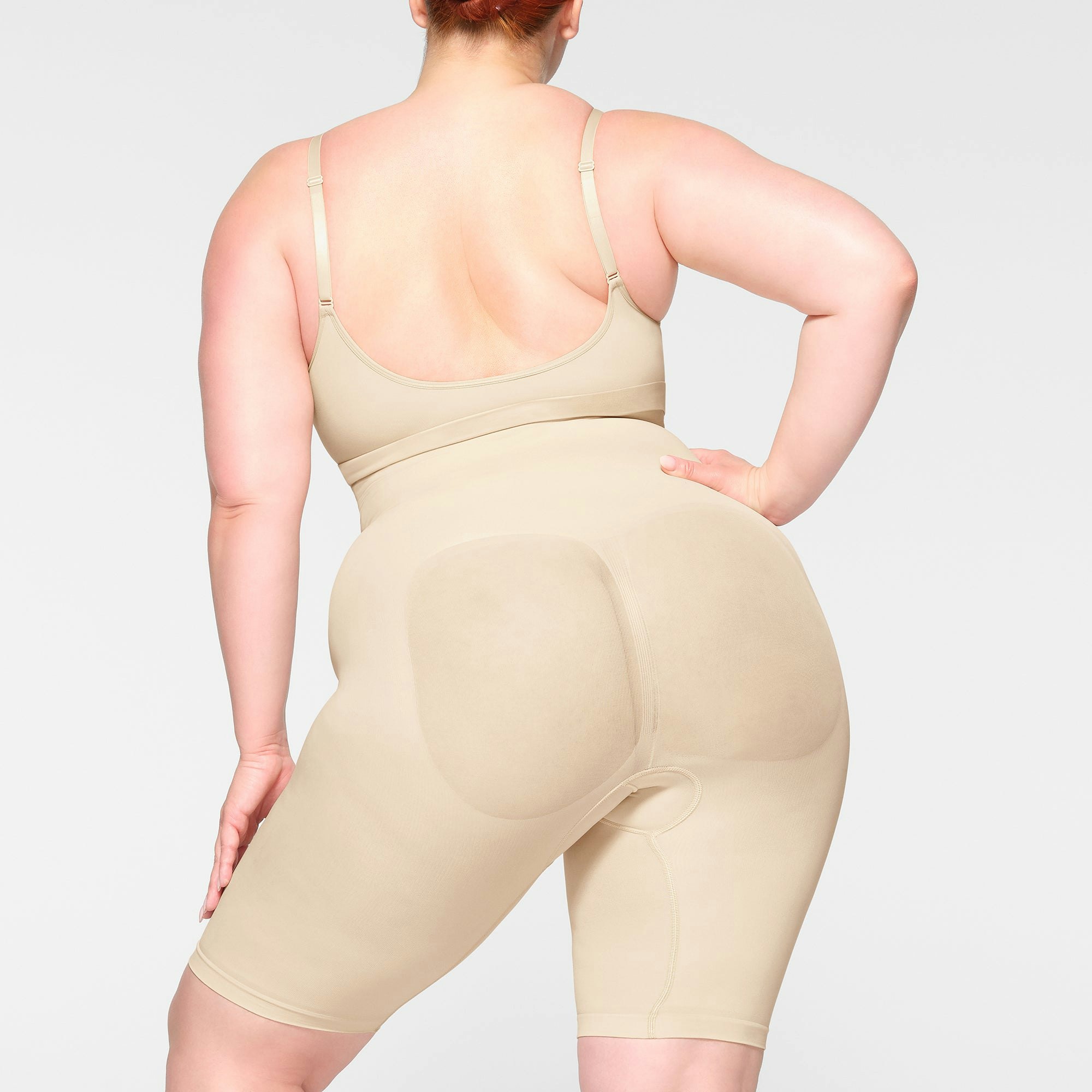 SEAMLESS SCULPT HIGH-WAISTED ABOVE THE KNEE SHORT ON A MODEL BACK VIEW