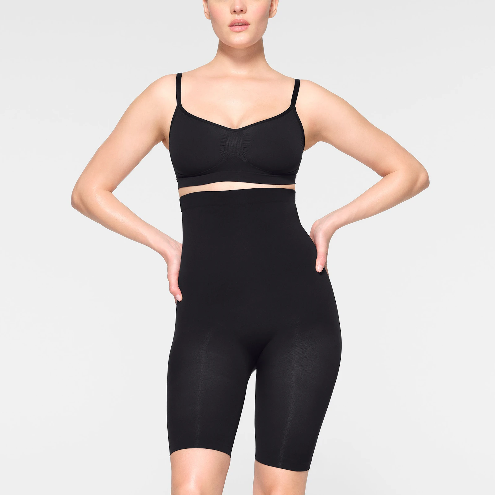 SEAMLESS SCULPT HIGH-WAISTED ABOVE THE KNEE SHORT WORN BY A MODEL IN FRONT VIEW | SEE: XXS, XS, S