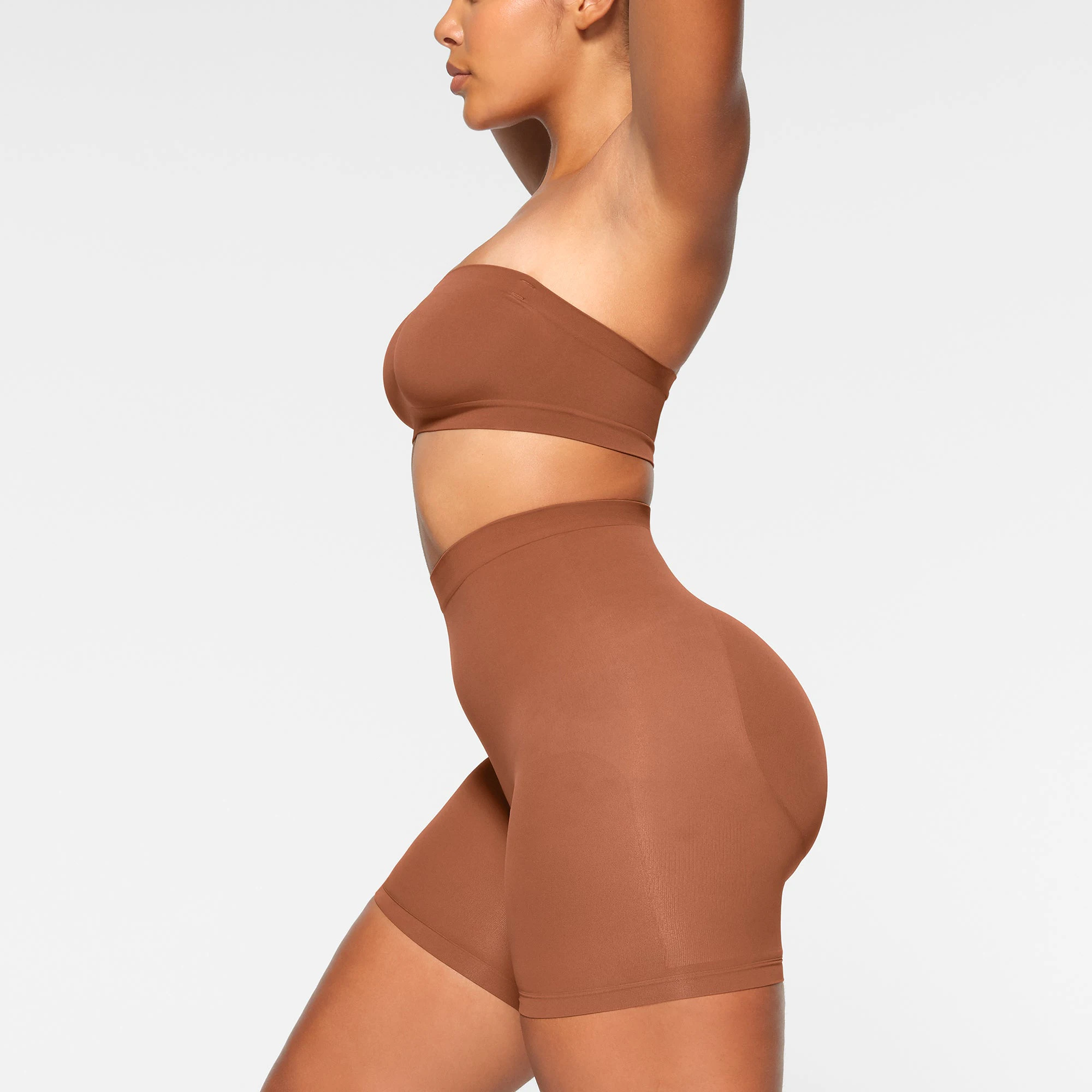SEAMLESS SCULPT BANDEAU WORN BY A MODEL IN SIDE VIEW