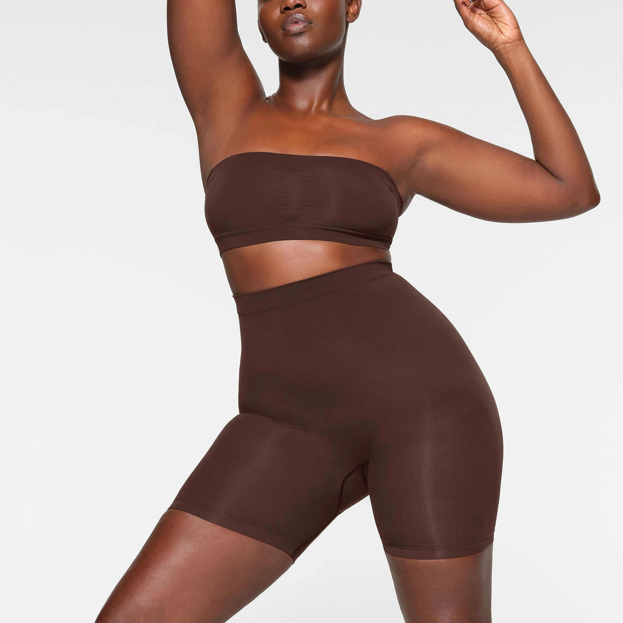 SEAMLESS SCULPT BANDEAU WORN BY A MODEL IN FRONT VIEW | SEE: M, L, XL