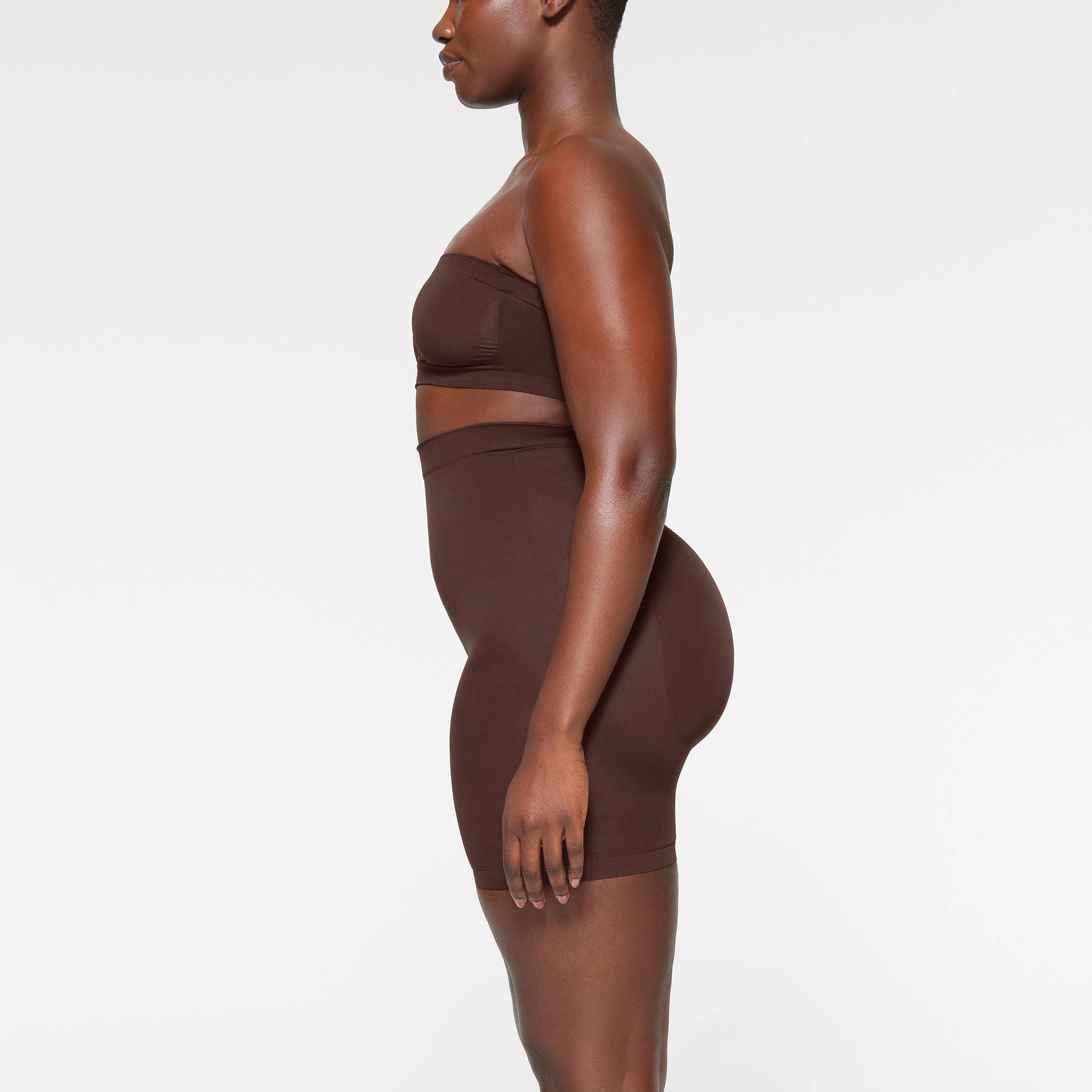 SEAMLESS SCULPT BANDEAU WORN BY A MODEL IN SIDE VIEW