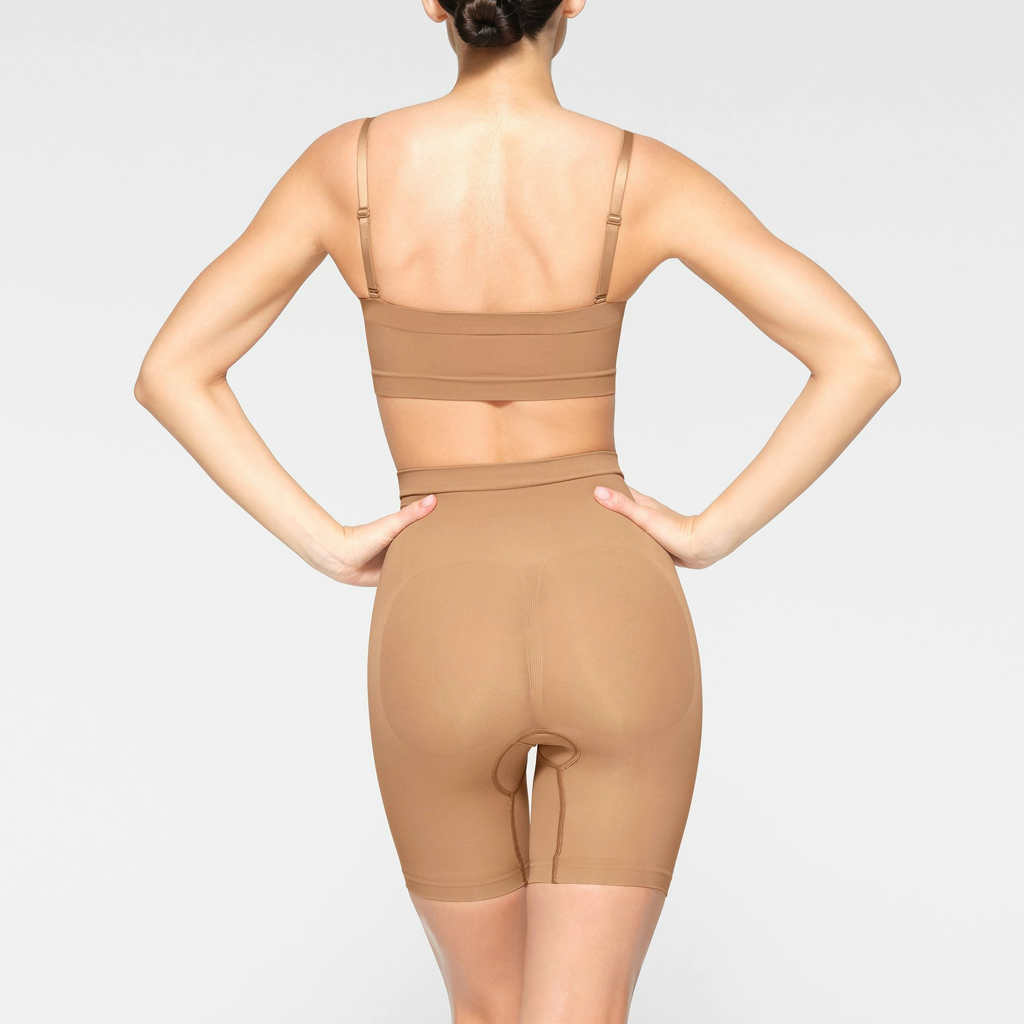 SEAMLESS SCULPT BANDEAU WORN BY A MODEL IN BACK VIEW