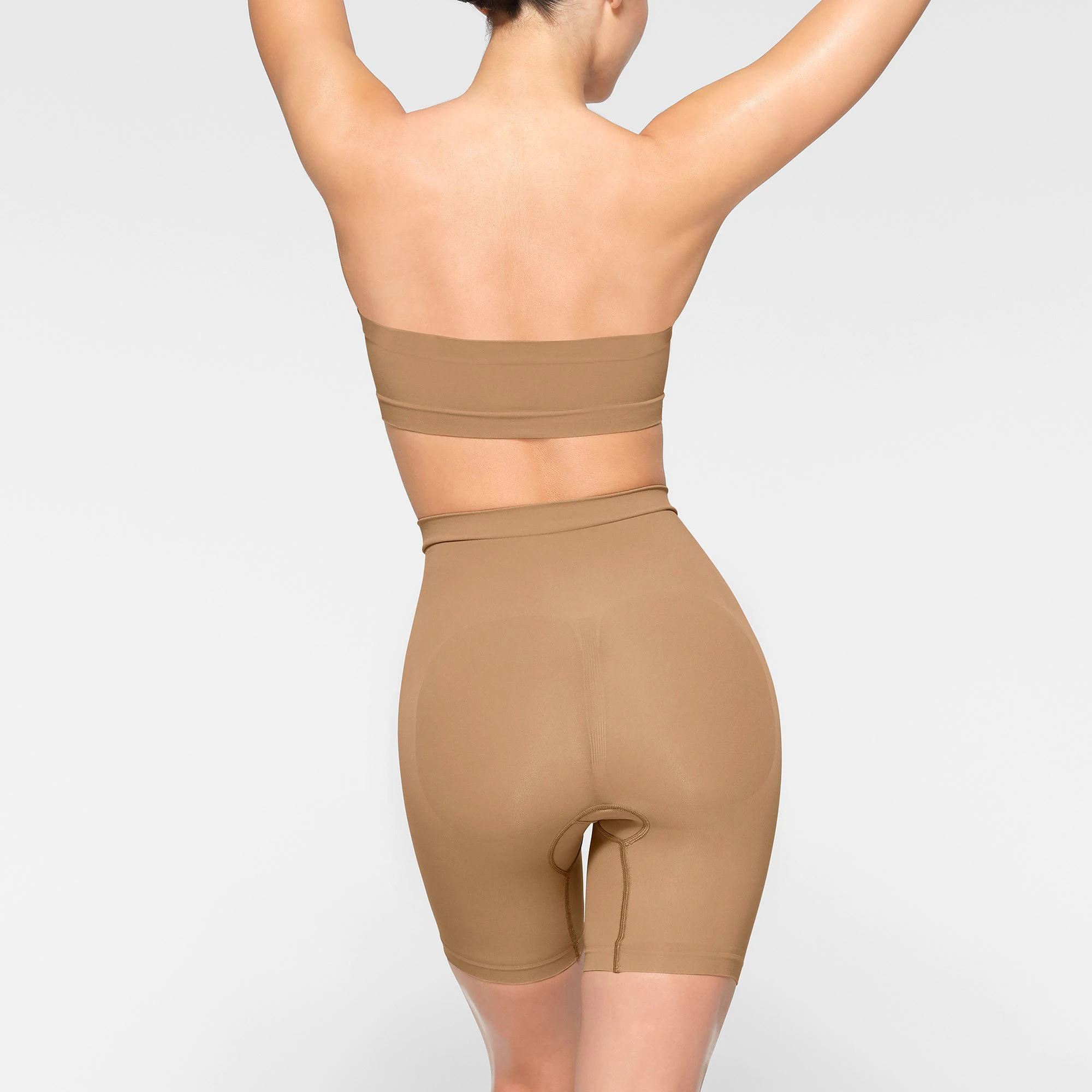 SEAMLESS SCULPT BANDEAU WORN BY A MODEL IN BACK VIEW