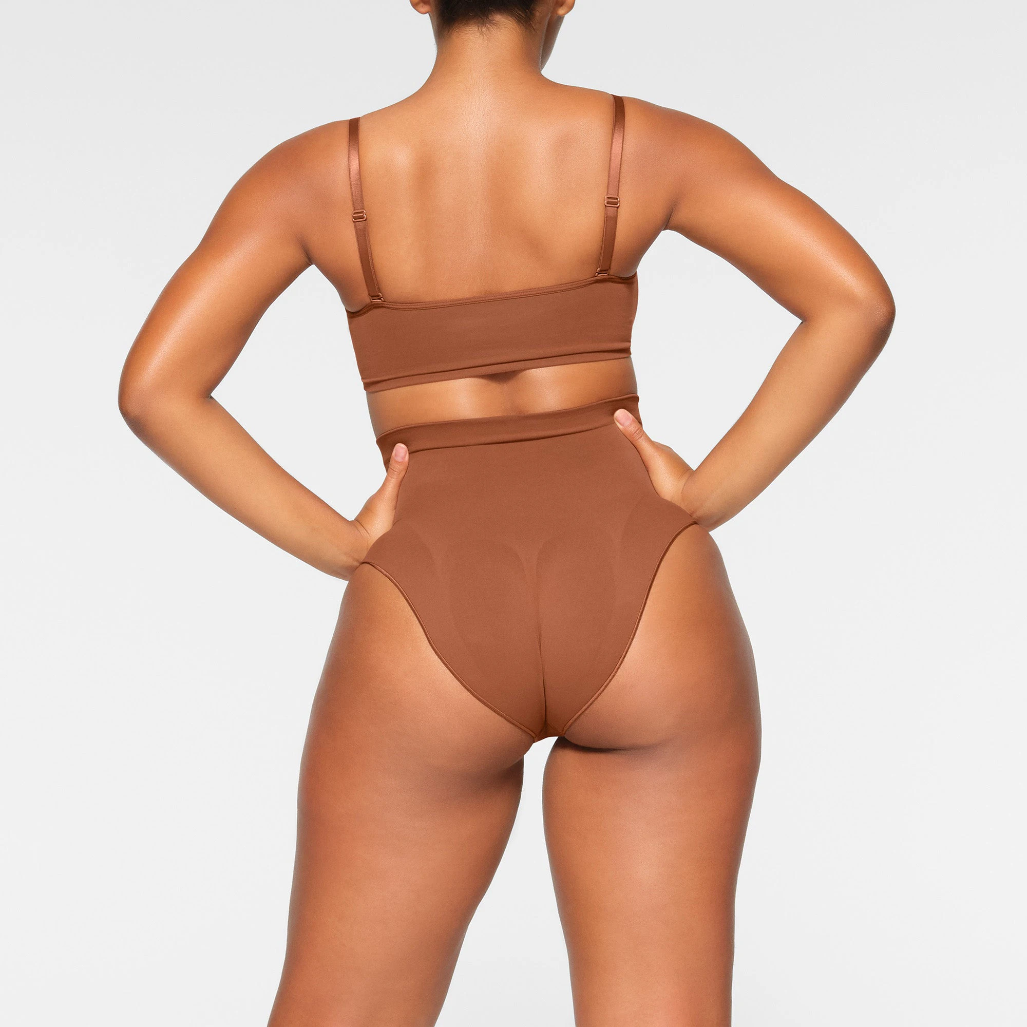 SEAMLESS SCULPT SCOOP NECK BRALETTE WORN BY A MODEL IN BACK VIEW