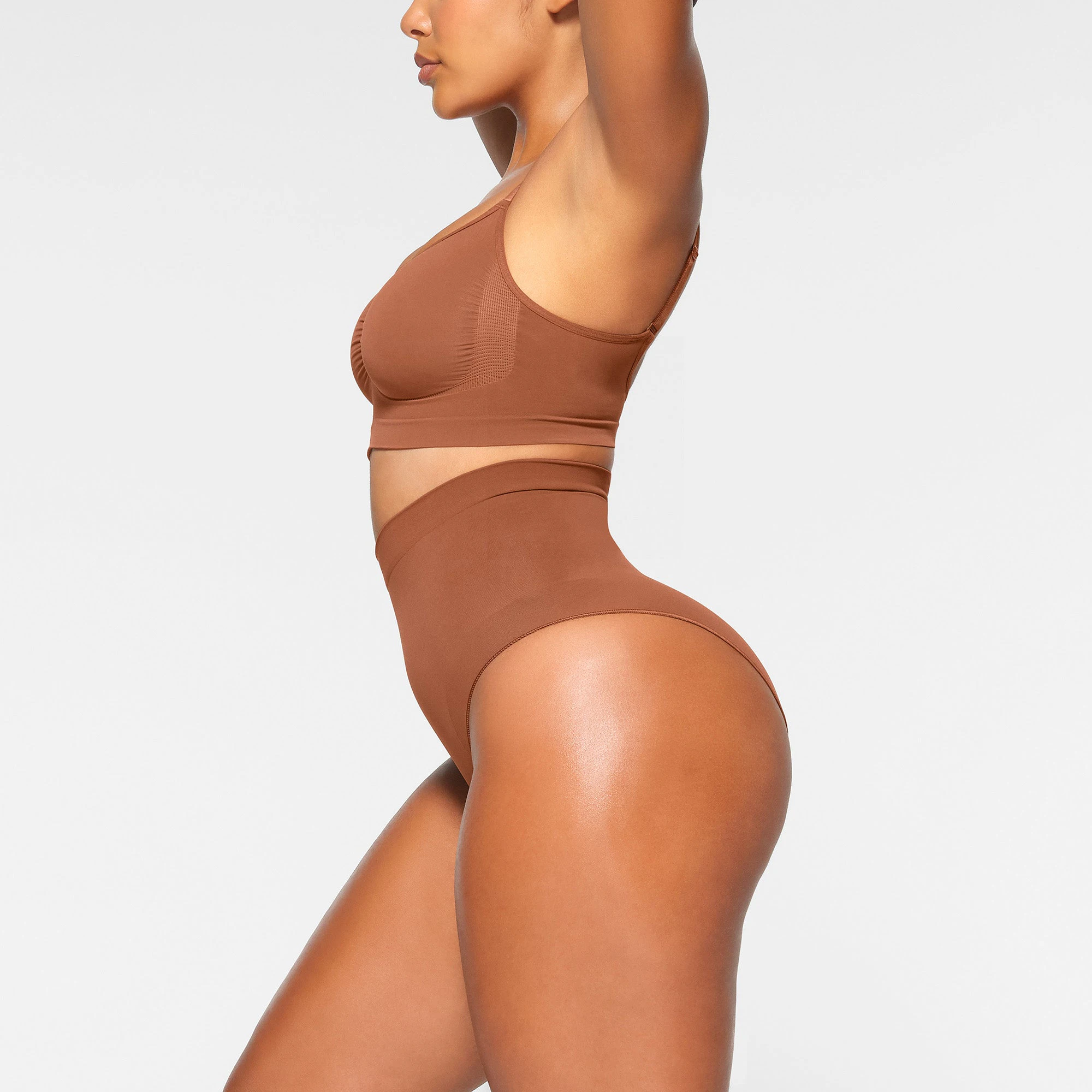 SEAMLESS SCULPT MID WAIST BRIEF WORN BY A MODEL IN SIDE VIEW