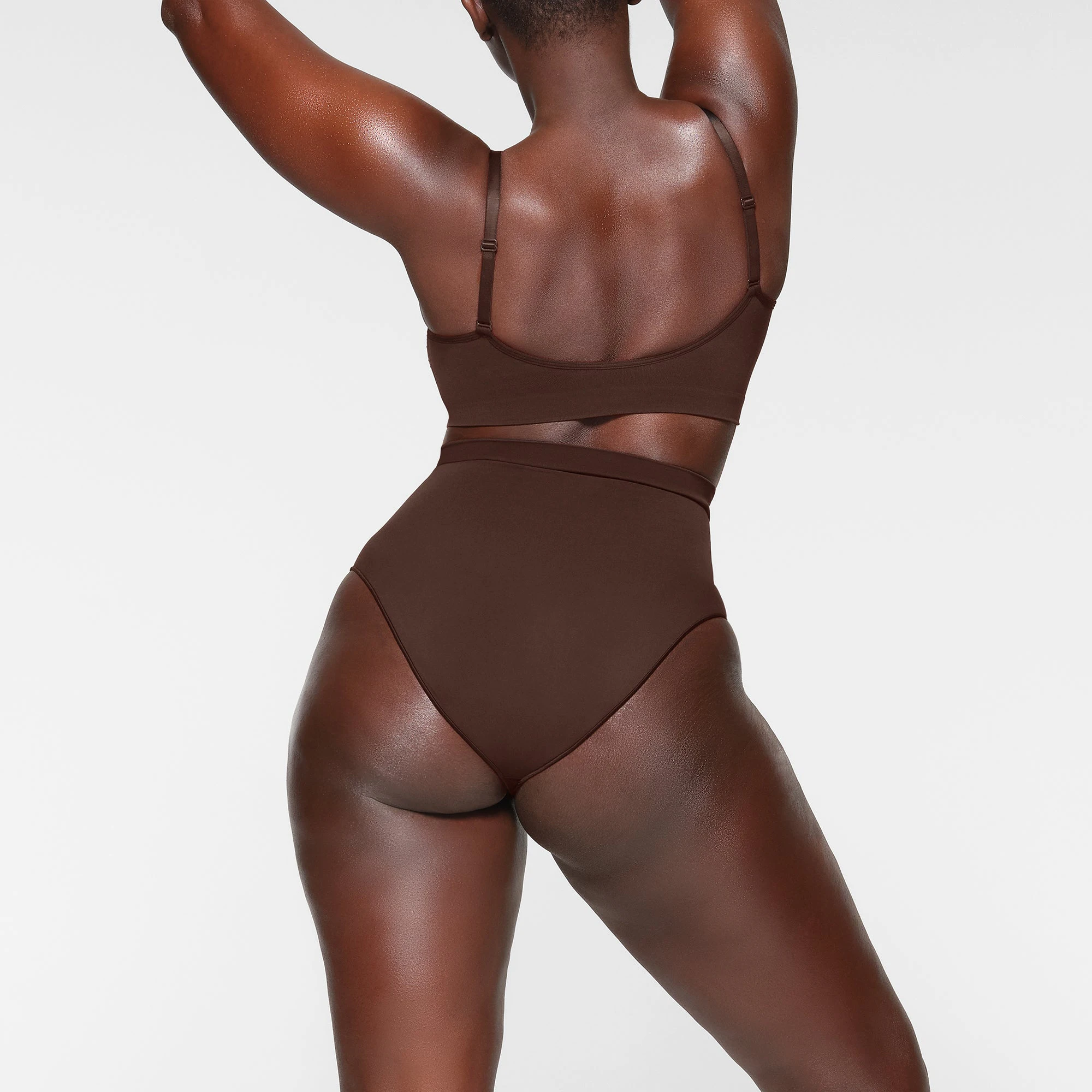 SEAMLESS SCULPT MID WAIST BRIEF ON A MODEL BACK VIEW