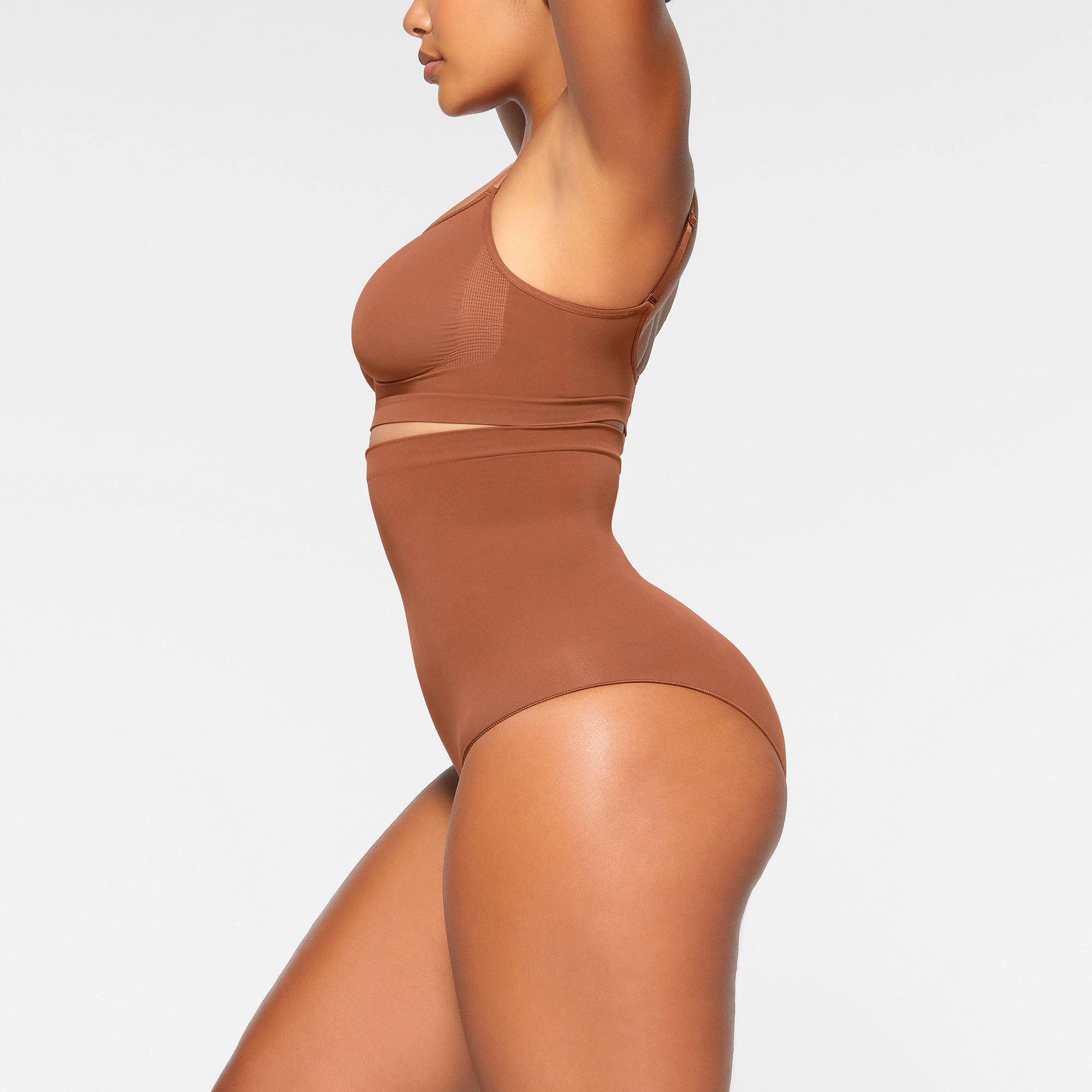 SEAMLESS SCULPT HIGH-WAISTED BRIEF WORN BY A MODEL IN SIDE VIEW