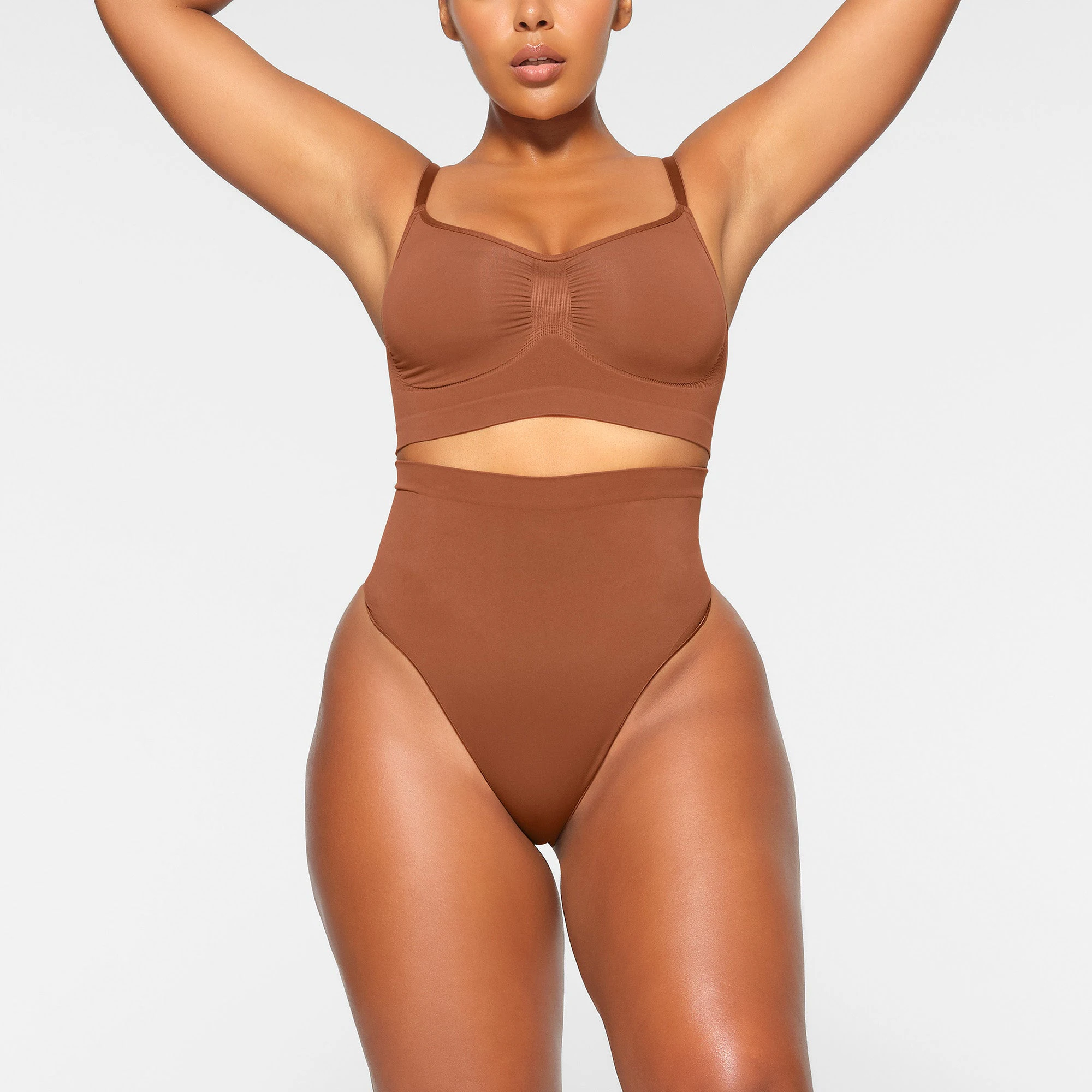SEAMLESS SCULPT HIGH-WAISTED THONG WORN BY A MODEL IN FRONT VIEW | SEE: M, L, XL