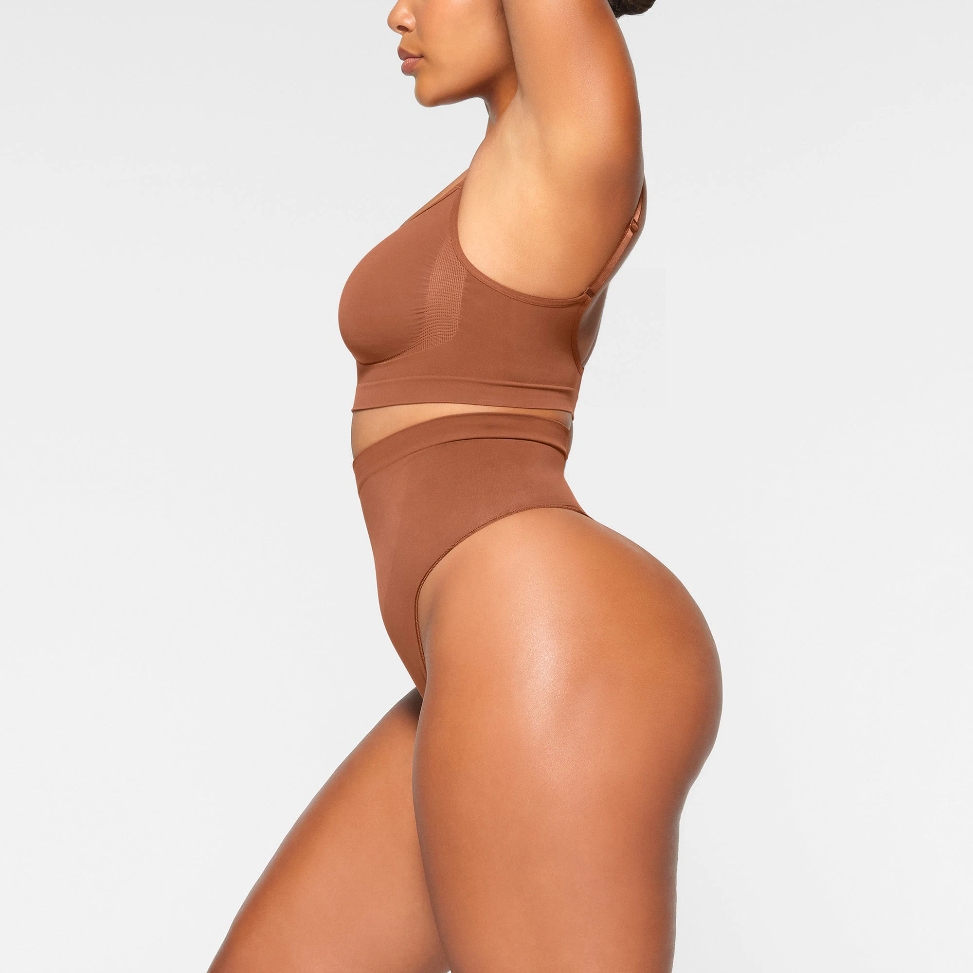 SEAMLESS SCULPT HIGH-WAISTED THONG WORN BY A MODEL IN SIDE VIEW