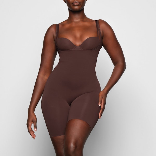 BUTT ENHANCING OPEN BUST BODYSUIT WORN BY A MODEL IN FRONT VIEW | SEE: M, L, XL