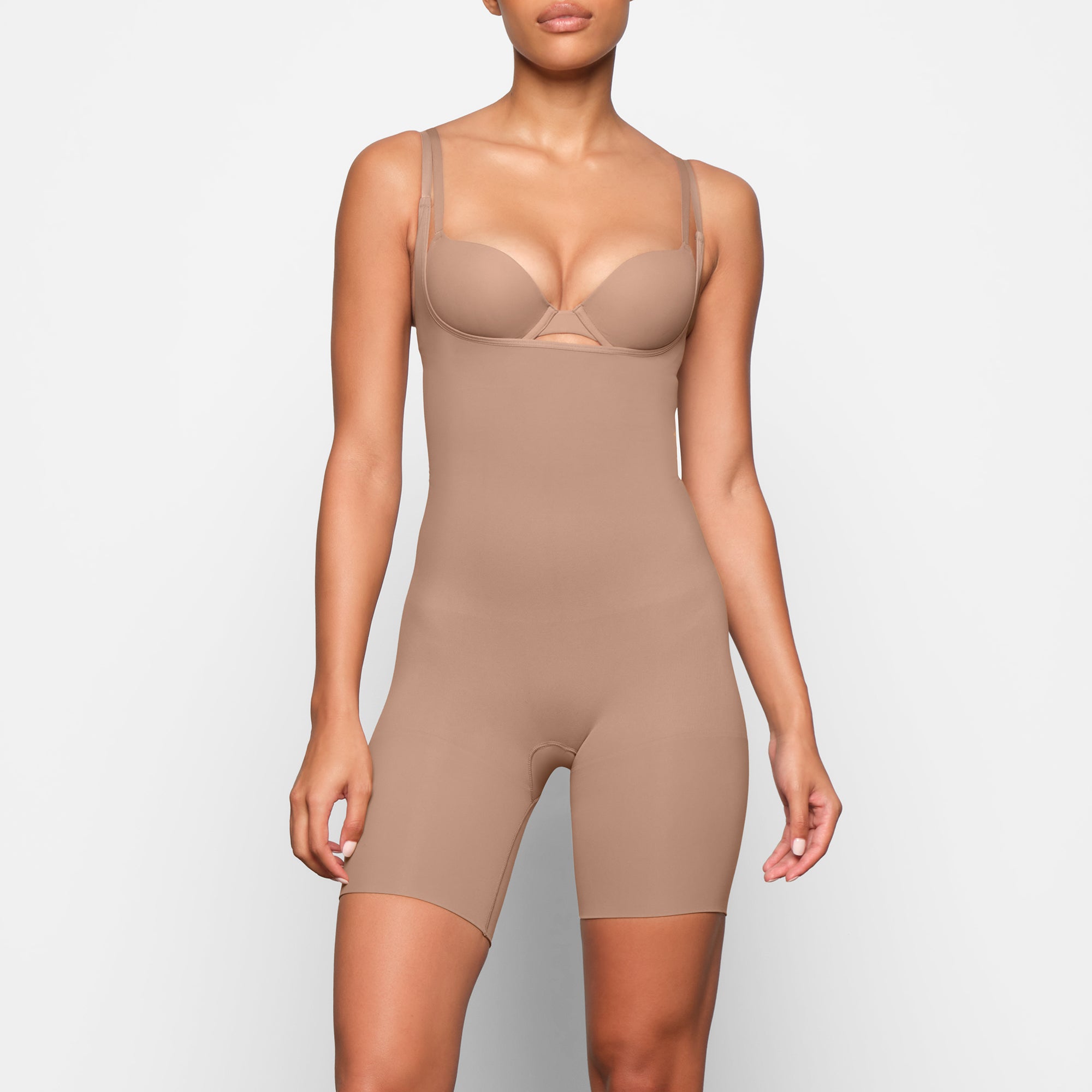 BUTT ENHANCING OPEN BUST BODYSUIT WORN BY A MODEL IN FRONT VIEW | SEE: XXS, XS, S