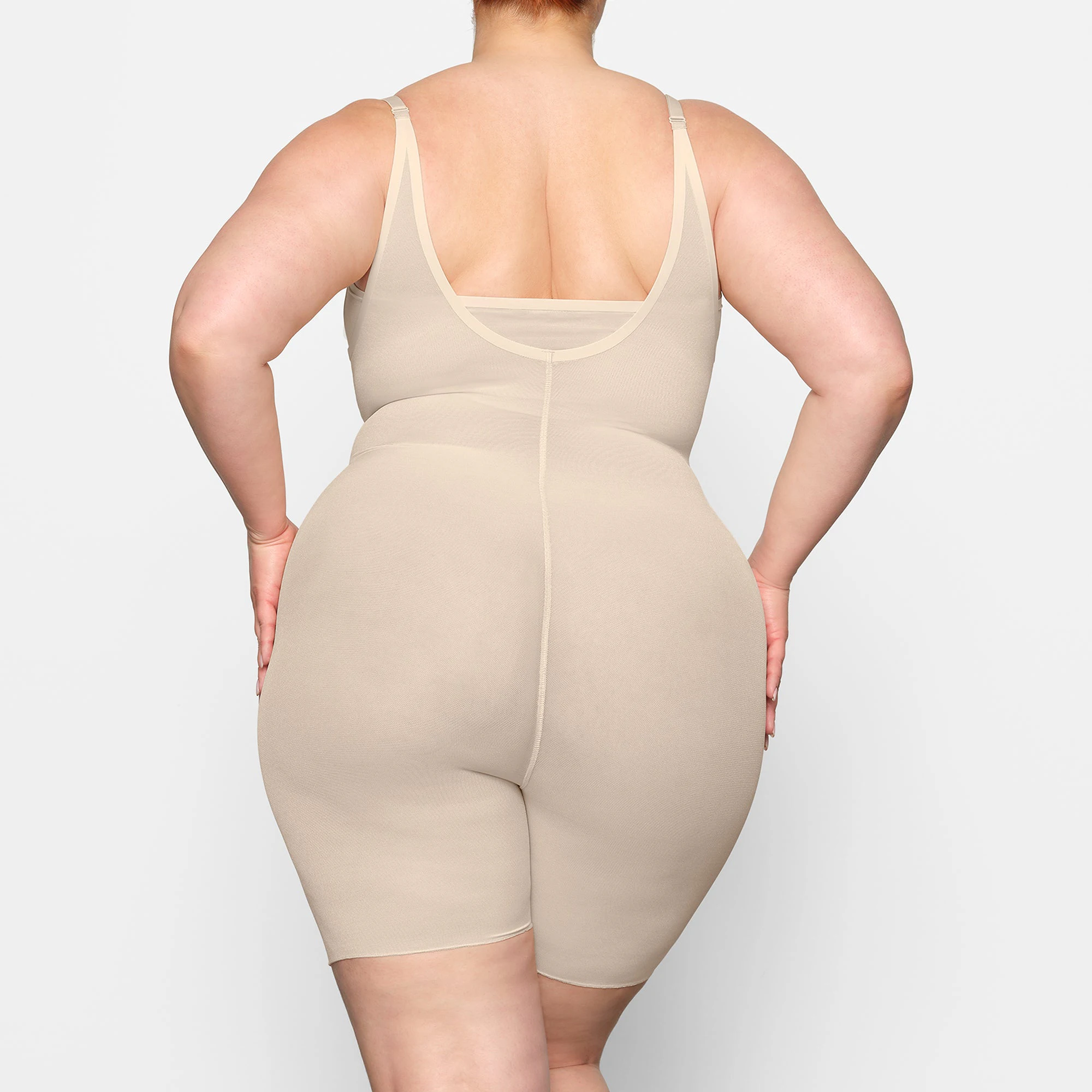 SHEER SCULPT OPEN BUST BODYSUIT ON A MODEL BACK VIEW