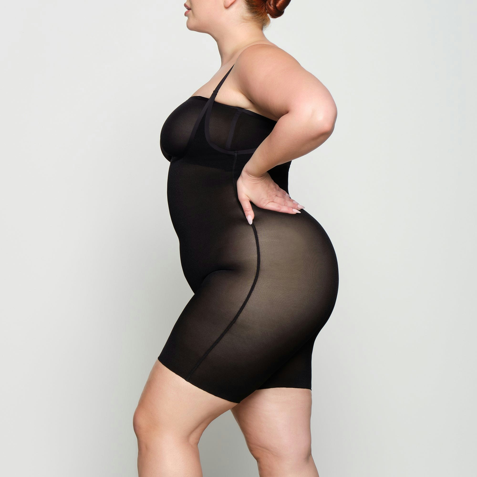 SHEER SCULPT OPEN BUST BODYSUIT WORN BY A MODEL IN SIDE VIEW