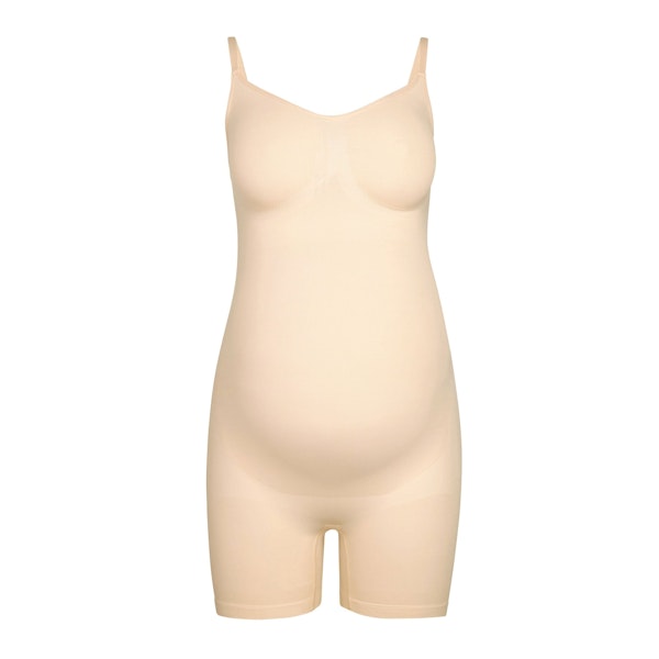 MATERNITY SCULPTING BODYSUIT MID THIGH | SAND (MATERNITY SHAPEWEAR, BODYSUITS) LAYS FLAT ON A WHITE BACKGROUND | FLT