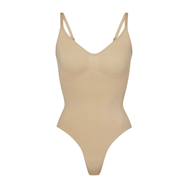 SEAMLESS SCULPT THONG BODYSUIT | CLAY (SHAPEWEAR BODYSUITS) LAYS FLAT ON A WHITE BACKGROUND | FLT