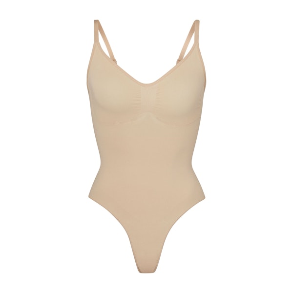 SEAMLESS SCULPT THONG BODYSUIT | MICA (SHAPEWEAR BODYSUITS) LAYS FLAT ON A WHITE BACKGROUND | FLT