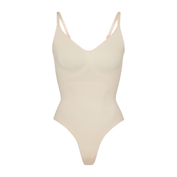 SEAMLESS SCULPT THONG BODYSUIT | SAND (SHAPEWEAR BODYSUITS) LAYS FLAT ON A WHITE BACKGROUND | FLT