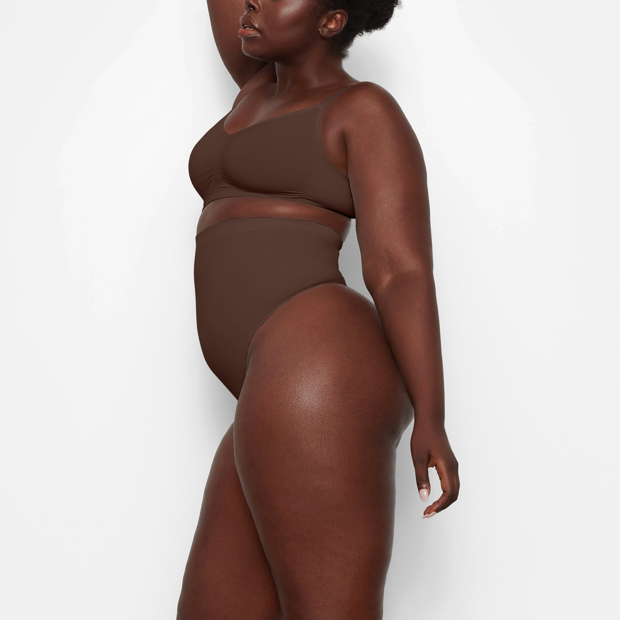 SEAMLESS SCULPT HIGH-WAISTED THONG WORN BY A MODEL IN SIDE VIEW