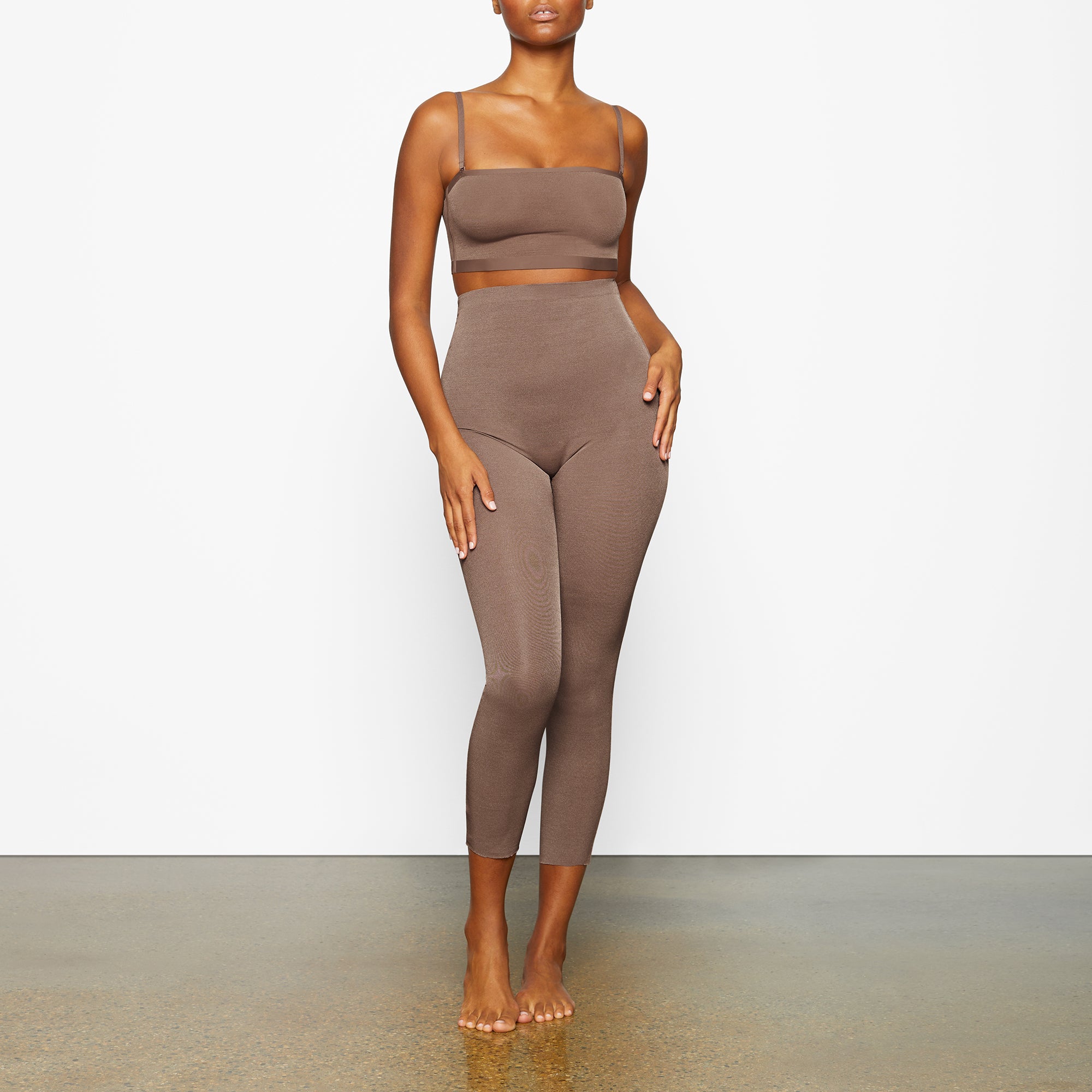 SHEER SCULPT LOW BACK LEGGING WORN BY A MODEL IN FRONT VIEW | SEE: M, L, XL