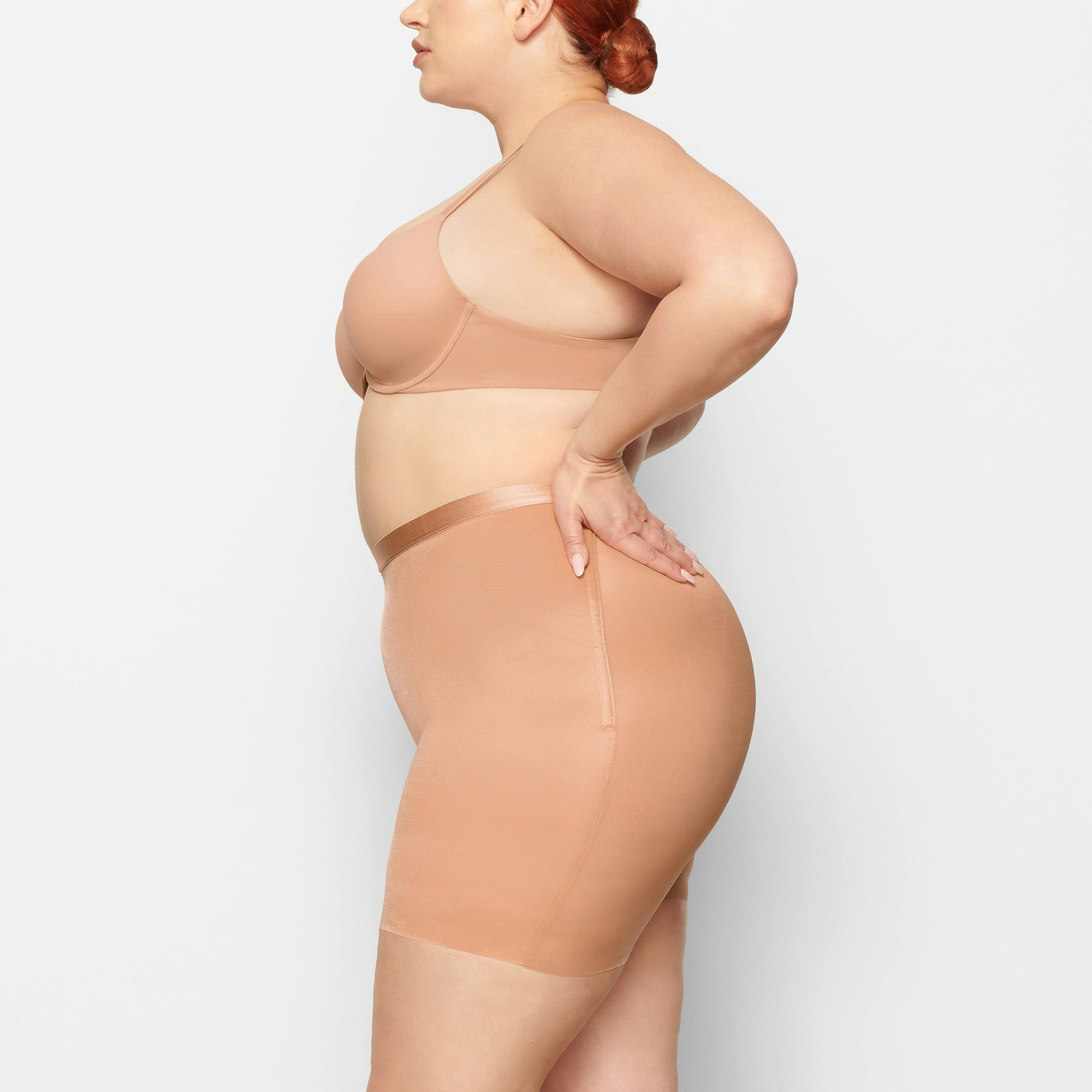 BARELY THERE LOW BACK SHORT WORN BY A MODEL IN SIDE VIEW