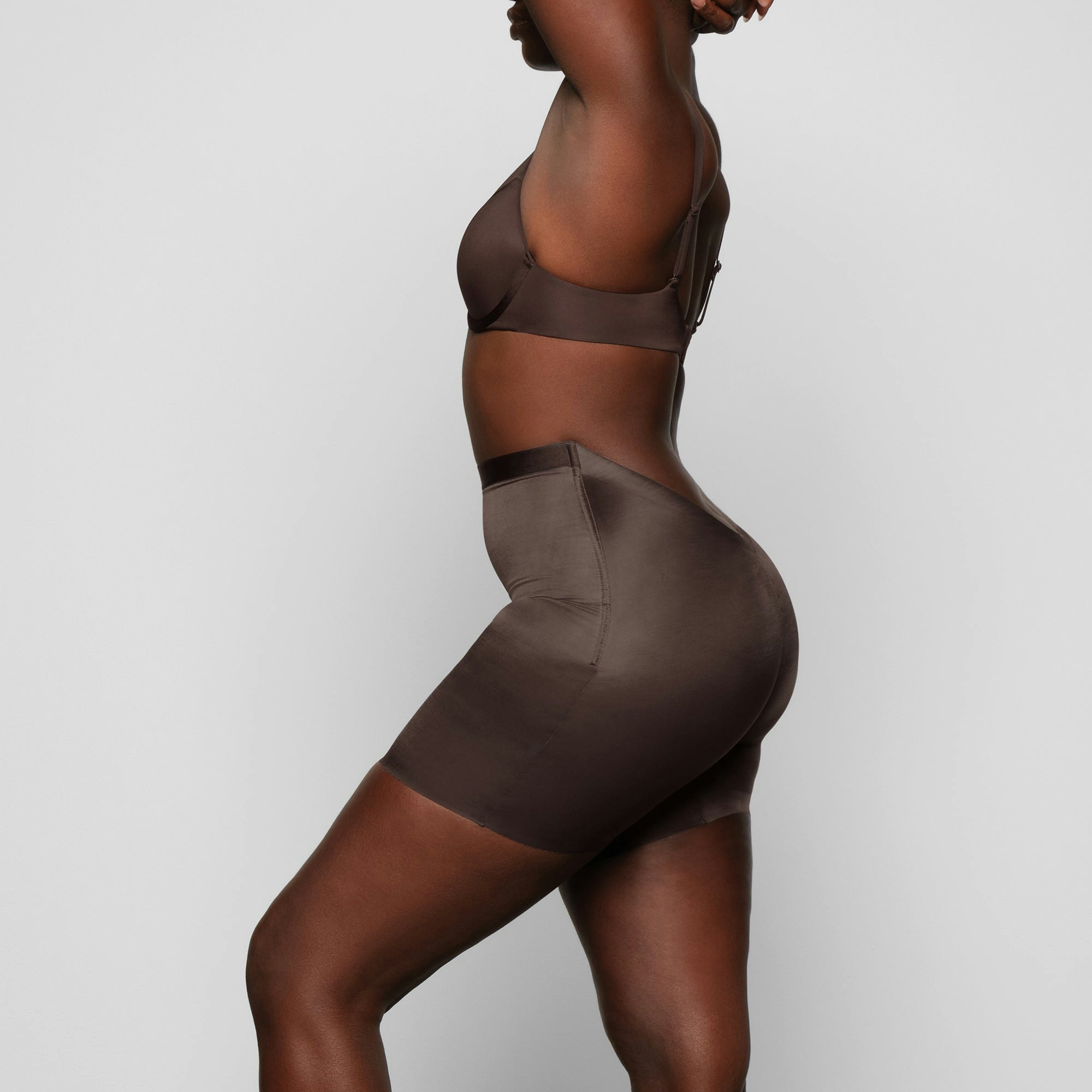 BARELY THERE LOW BACK SHORT WORN BY A MODEL IN SIDE VIEW