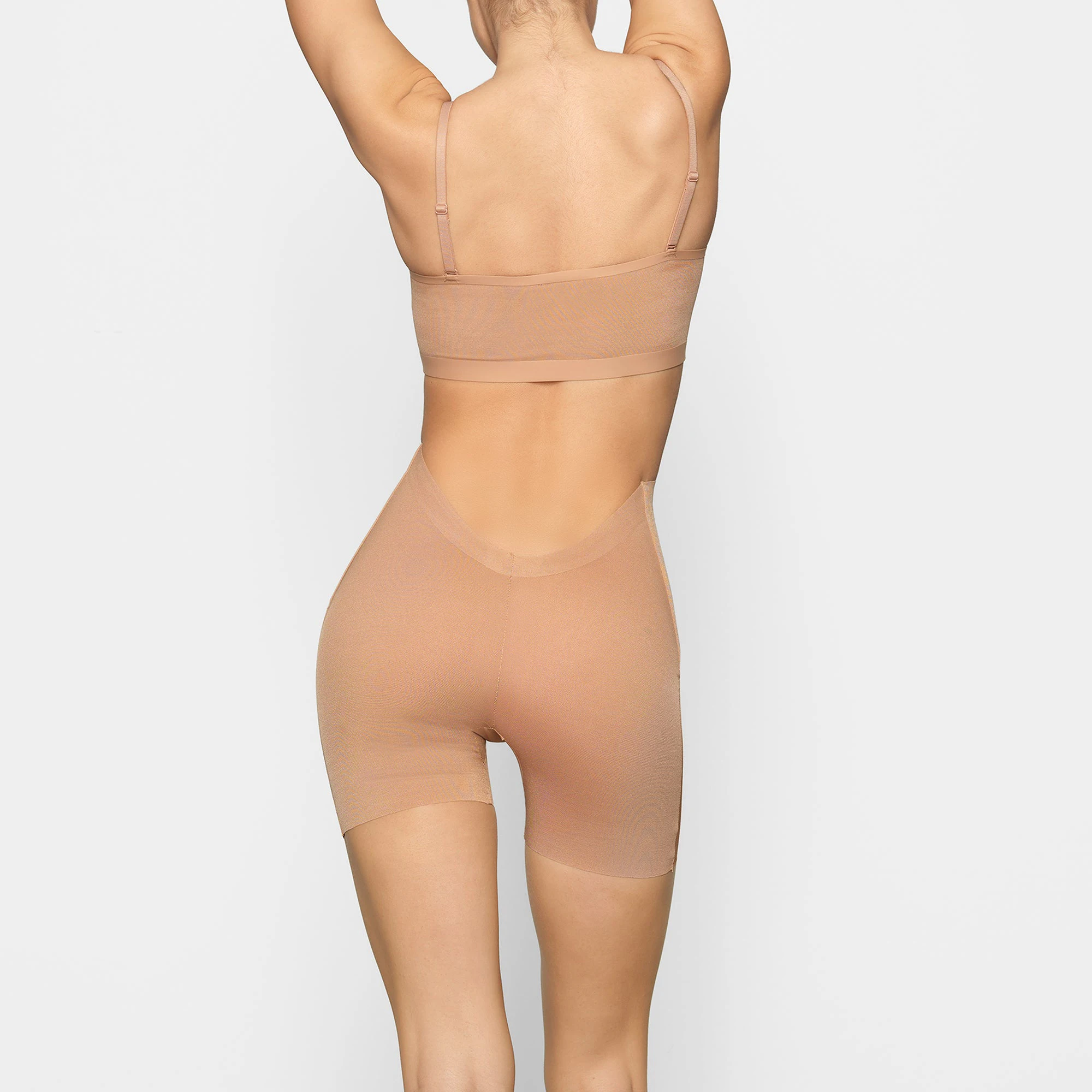 SHEER SCULPT LOW BACK SHORT | OCHRE FLAT ON A WHITE BACKGROUND