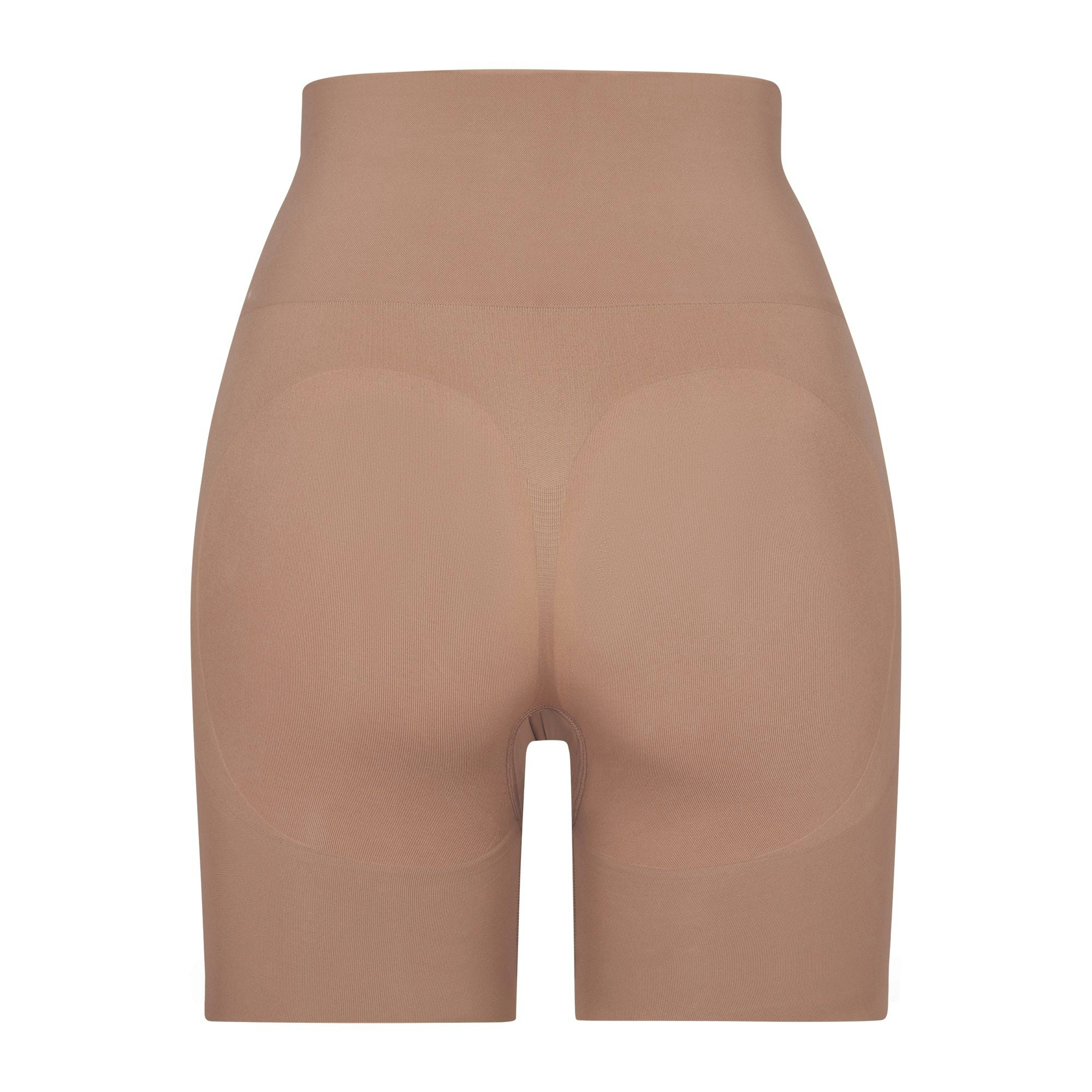 BUTT ENHANCING SHORT LAYS FLAT ON A WHITE BACKGROUND | FLT