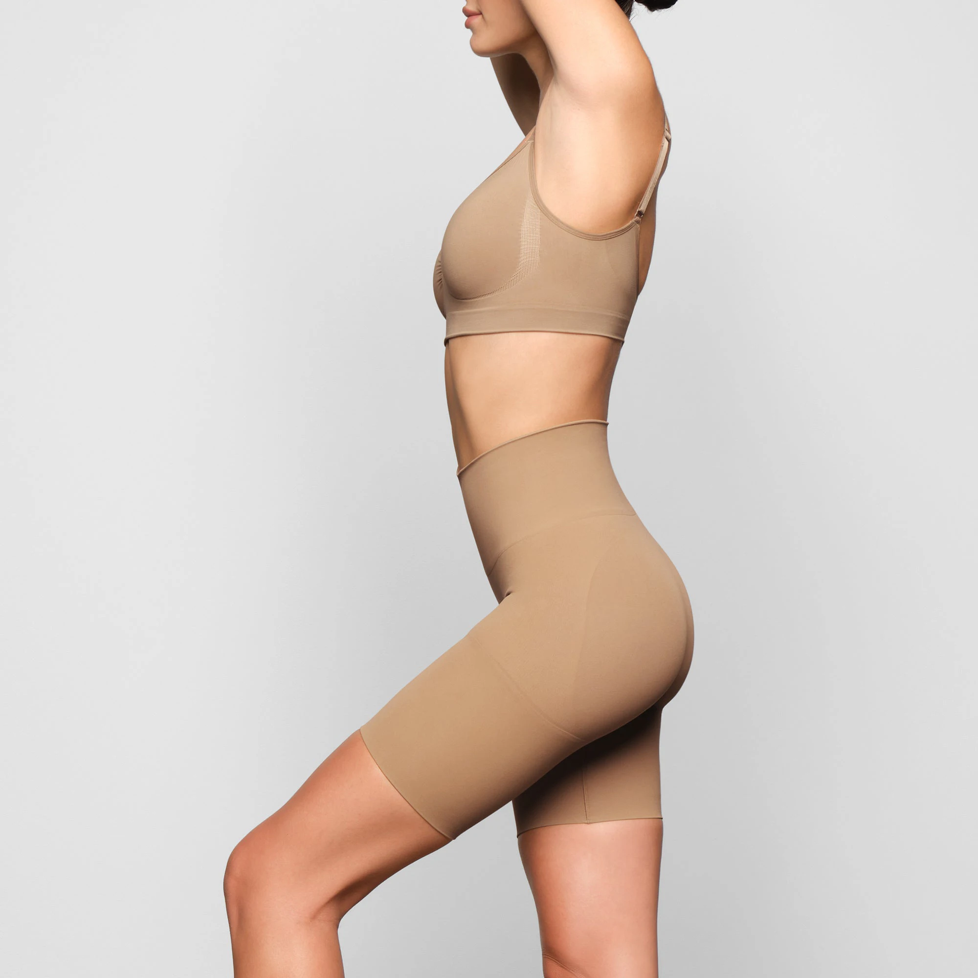 BUTT ENHANCING SHORT WORN BY A MODEL IN SIDE VIEW