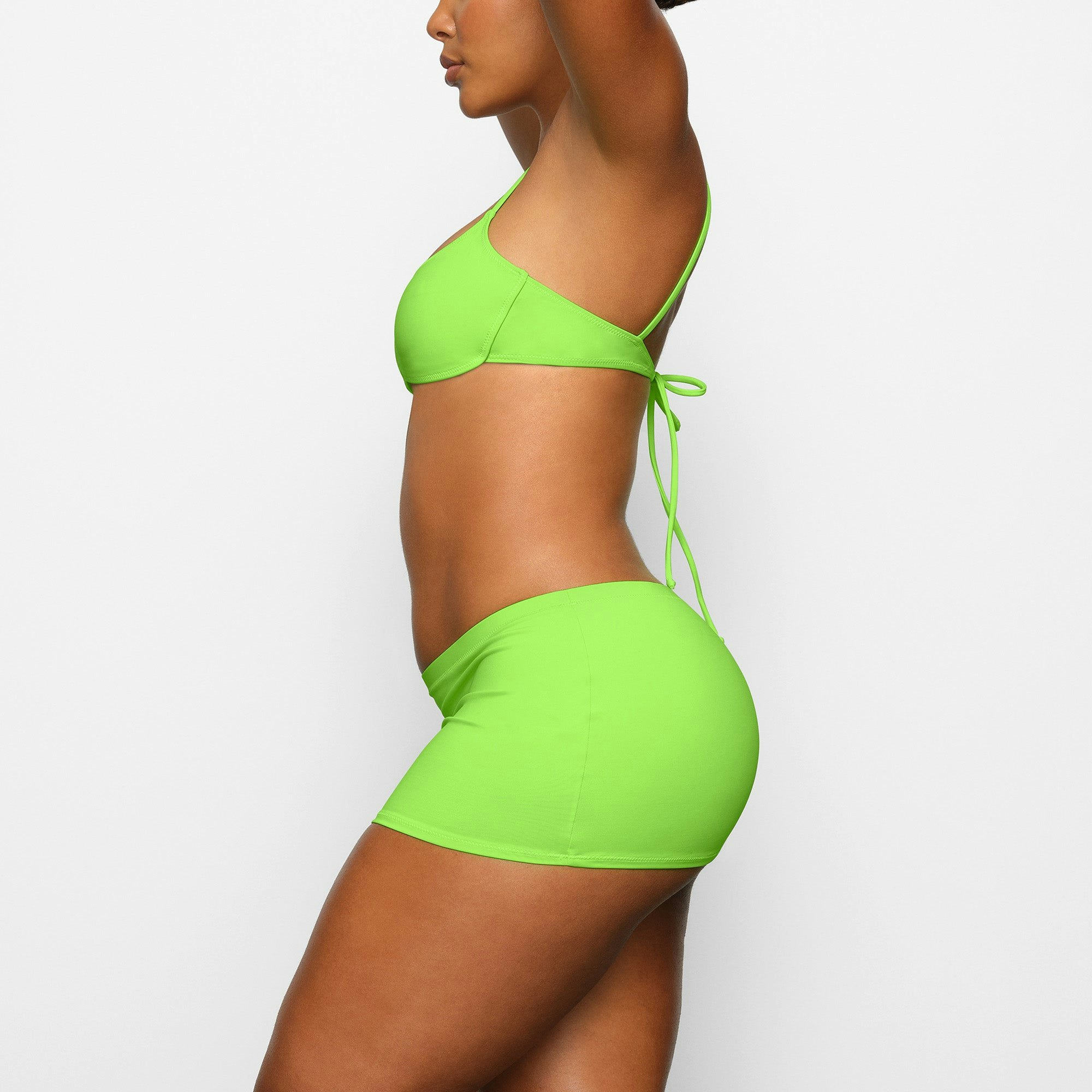 SWIM MICRO MINI SKIRT WORN BY A MODEL IN SIDE VIEW