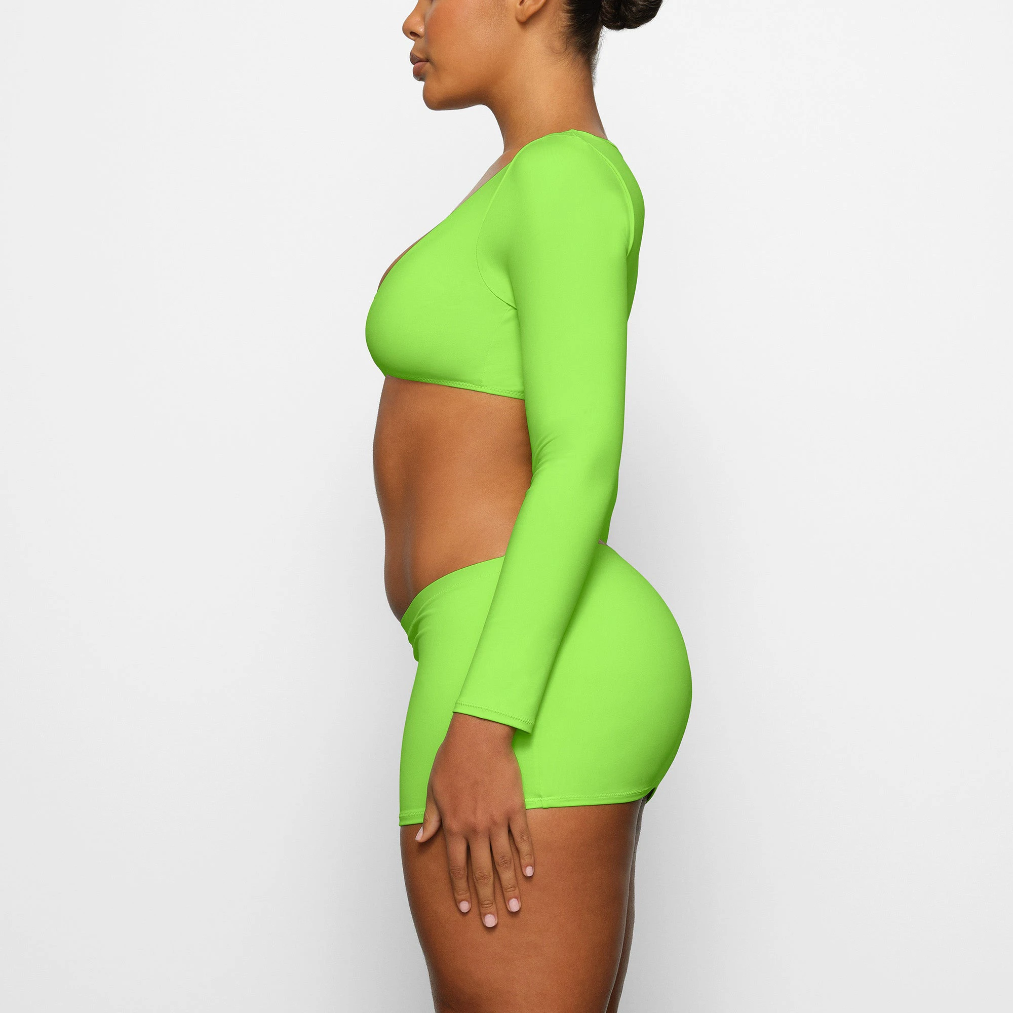 SWIM LONG SLEEVE SHRUG WORN BY A MODEL IN SIDE VIEW