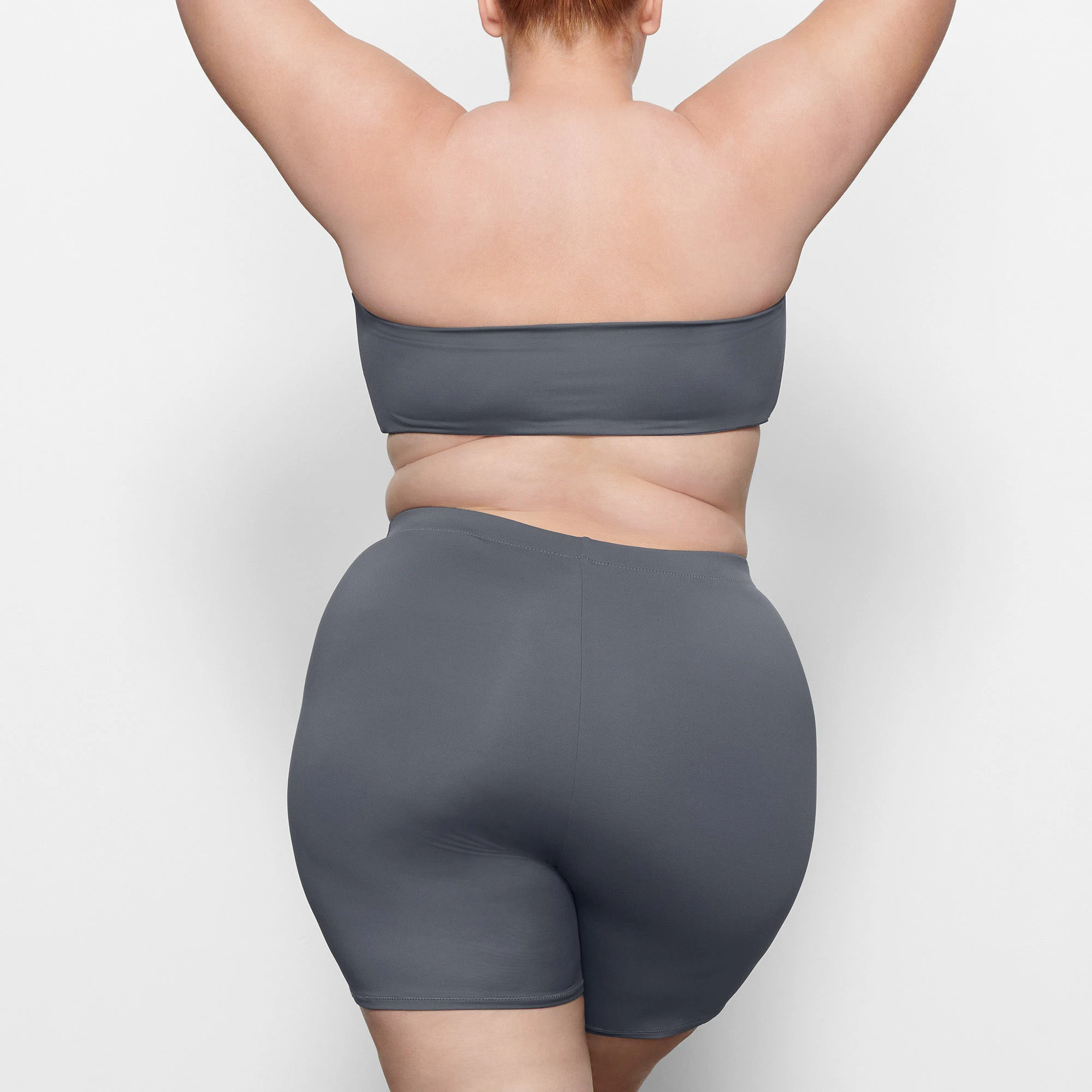 SWIM MID WAIST SHORTS ON A MODEL BACK VIEW