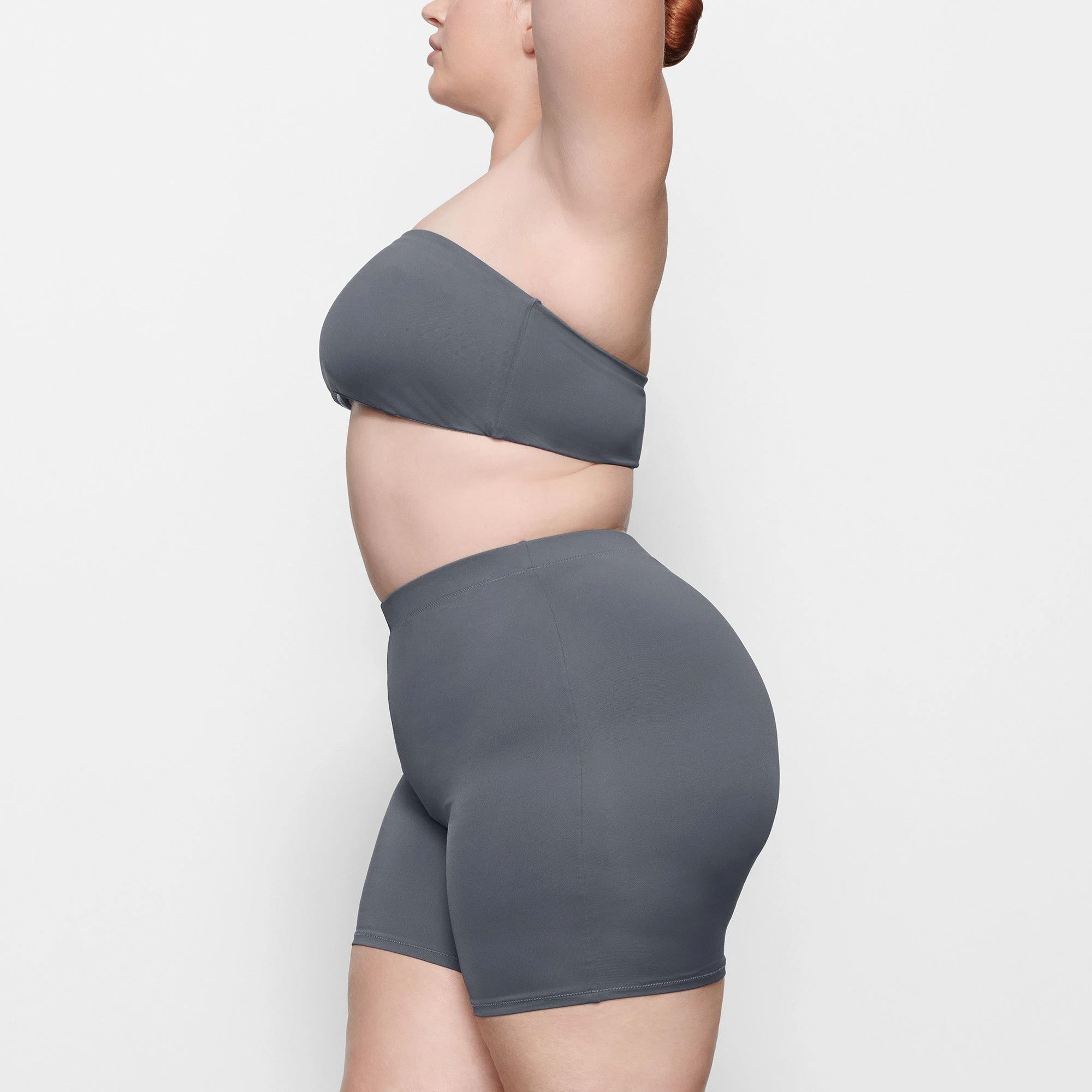 SWIM MID WAIST SHORTS WORN BY A MODEL IN SIDE VIEW
