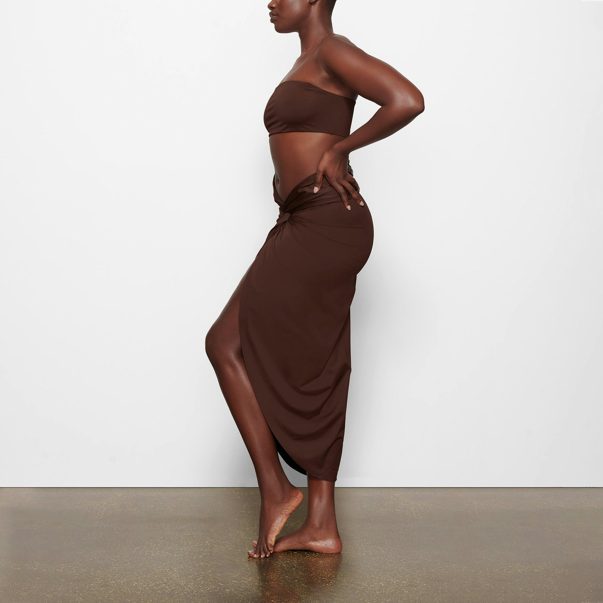 SWIM SARONG SKIRT WORN BY A MODEL IN SIDE VIEW