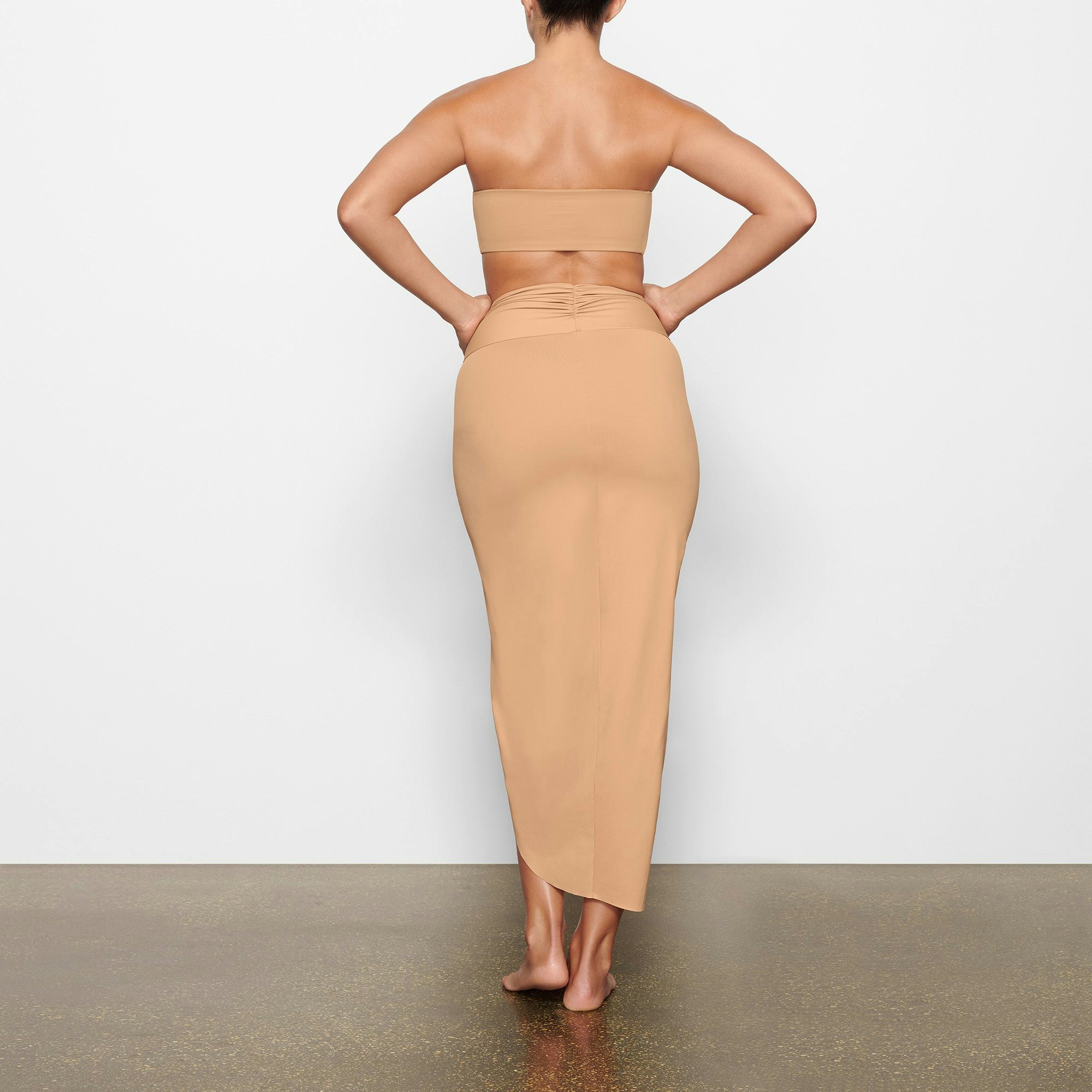 SWIM SARONG SKIRT WORN BY A MODEL IN BACK VIEW