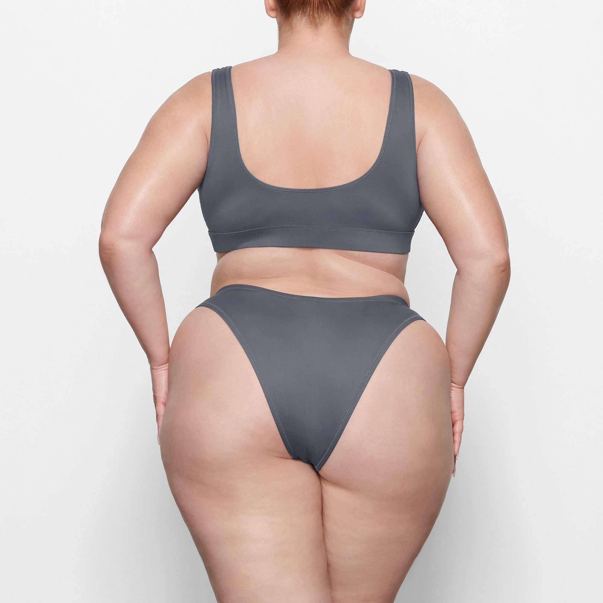 SWIM CHEEKY TANGA BOTTOMS ON A MODEL BACK VIEW