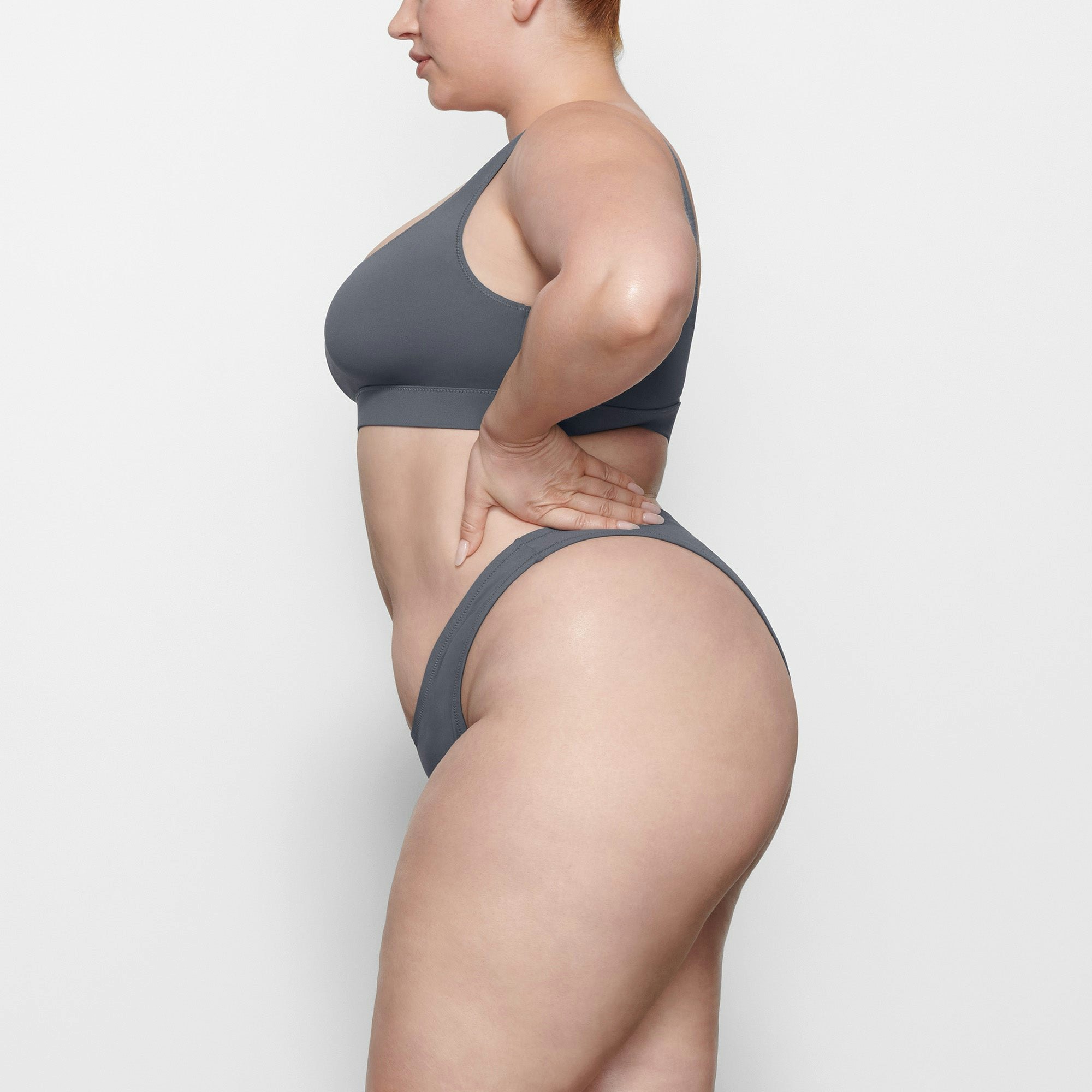 SWIM CHEEKY TANGA BOTTOMS WORN BY A MODEL IN SIDE VIEW