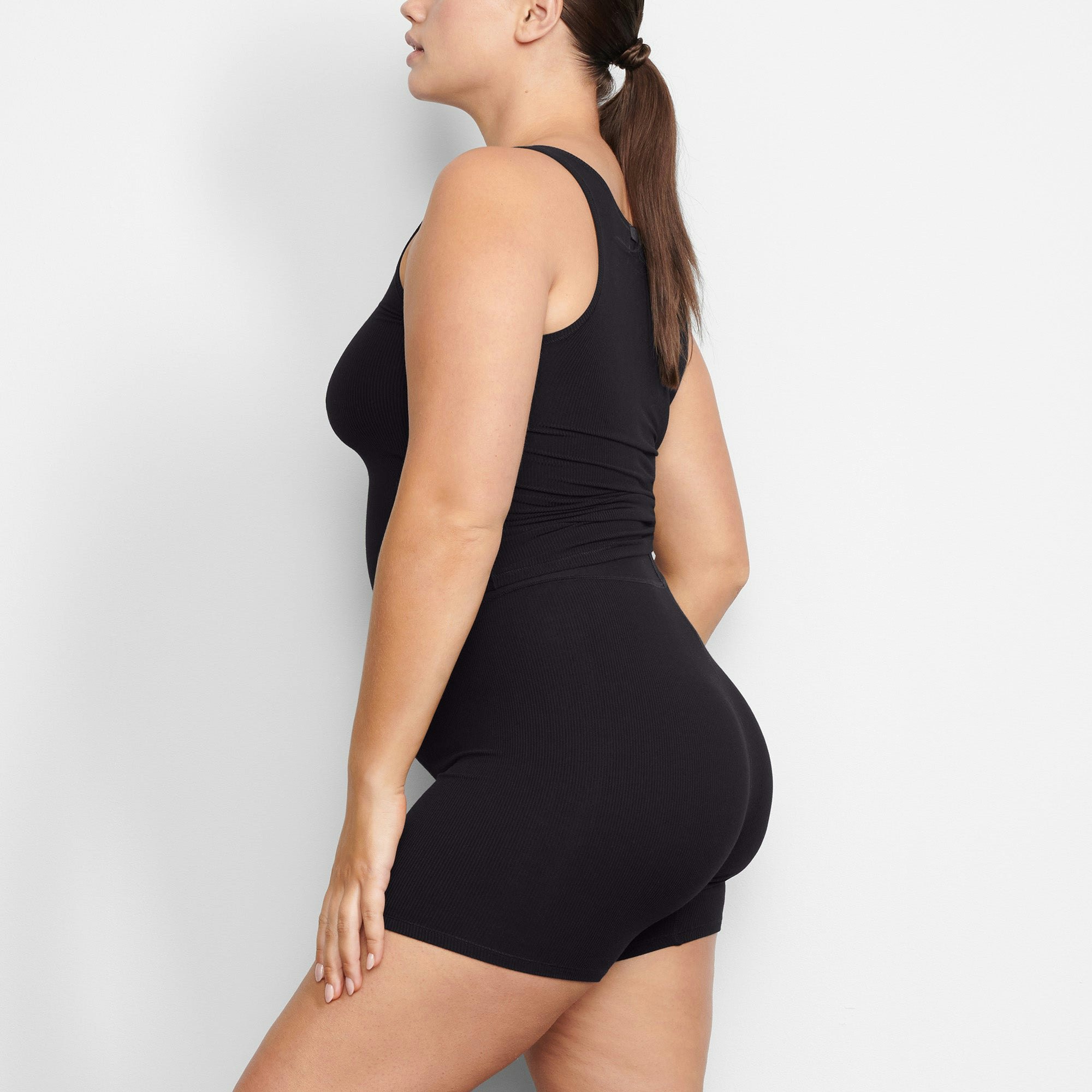 WORN BY A MODEL IN SIDE VIEW SOFT LOUNGE BOXER IN ONYX